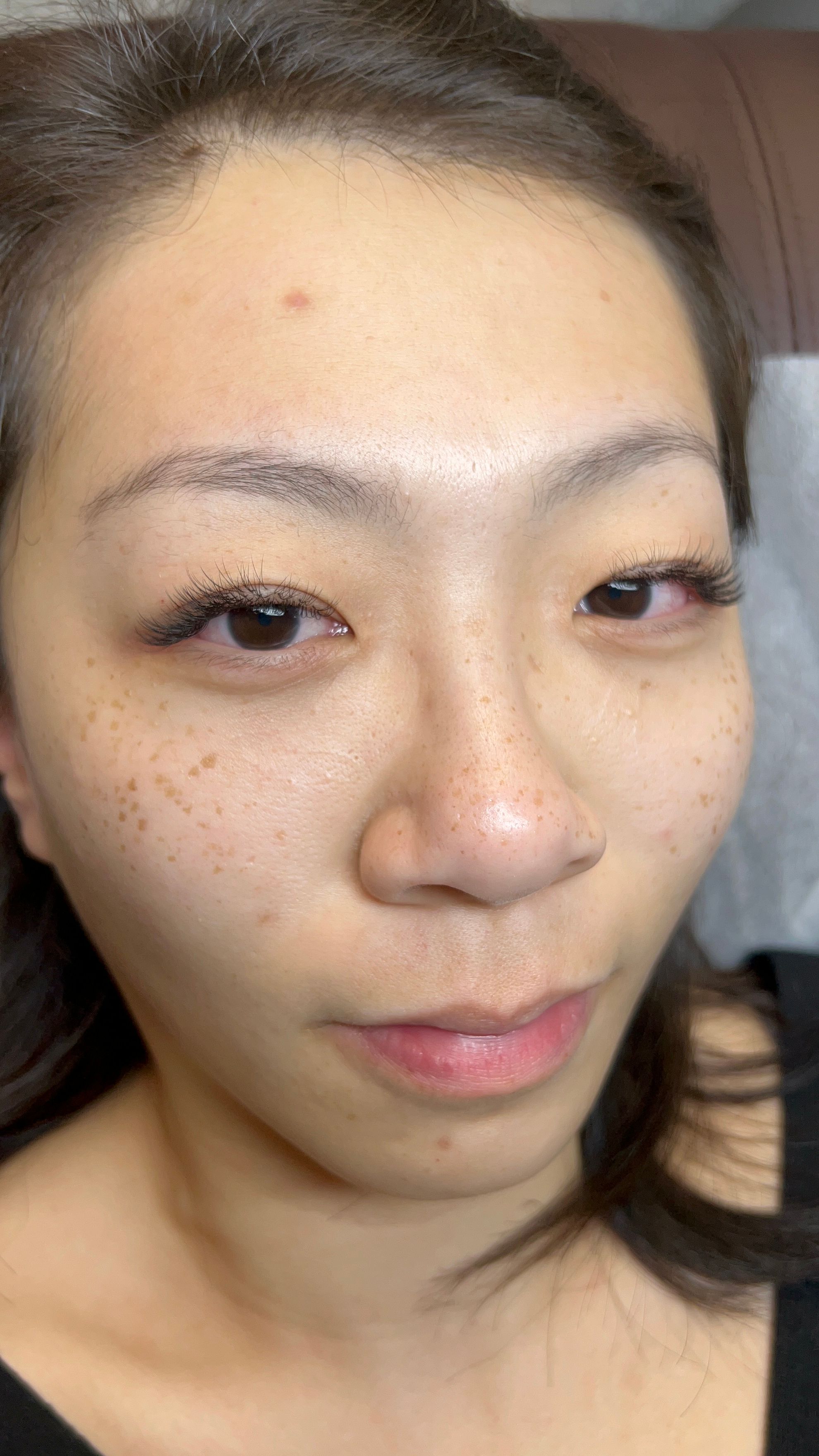 Close-up of wispy eyelash extensions with longer outer lashes