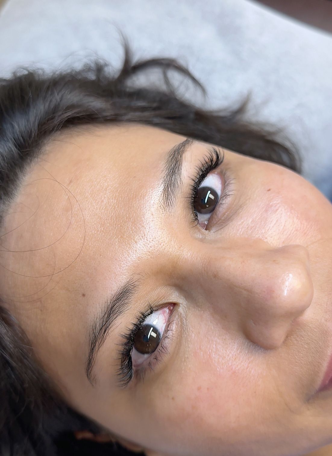 Both eyes with longer, softly curled eyelash extensions