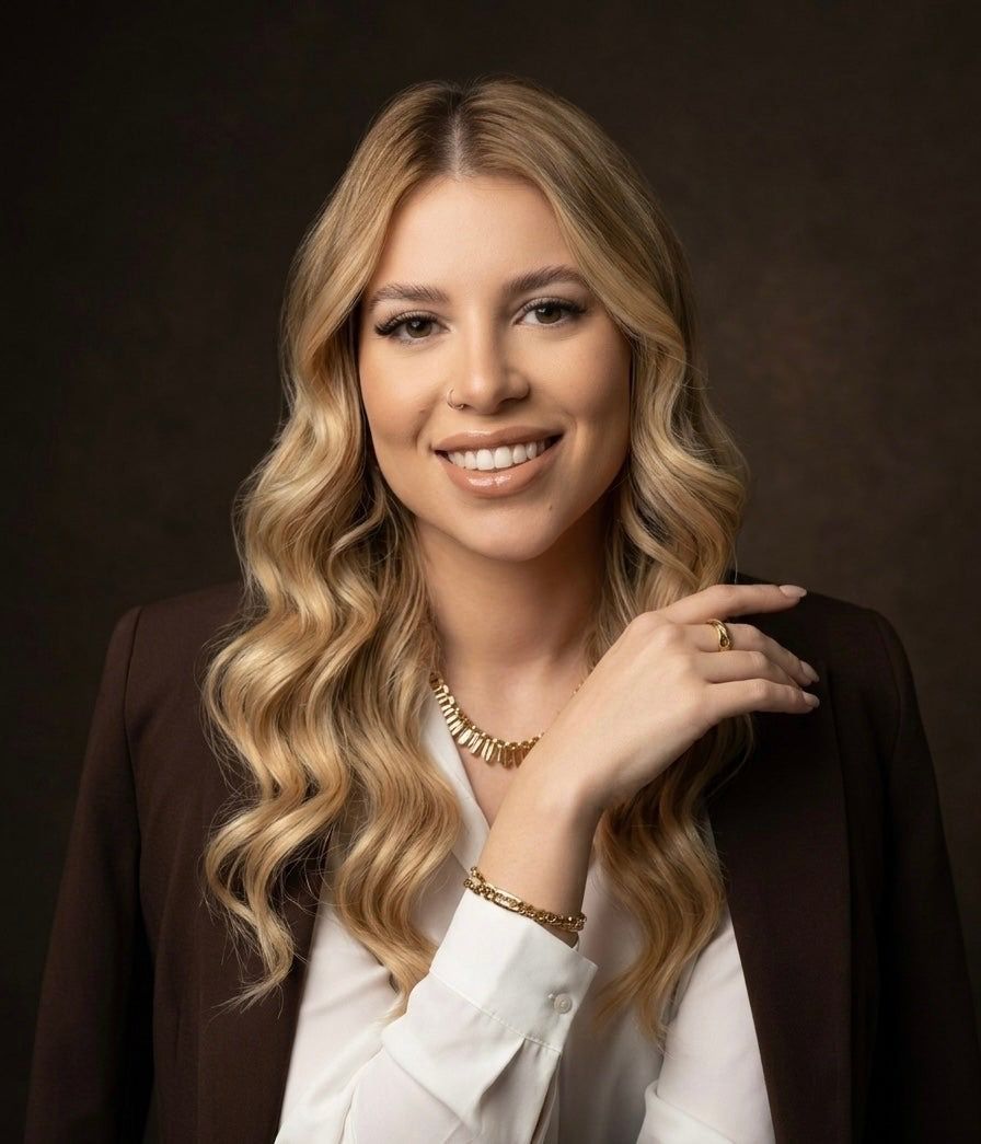 A portrait of a smiling woman with curly blond hair