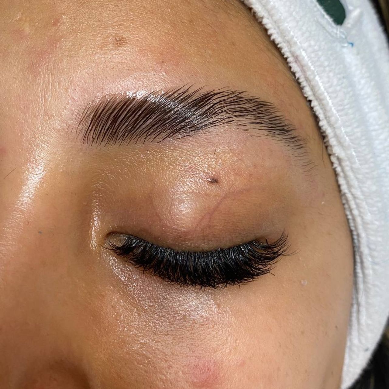 Close-up of a closed eye with a laminated brow