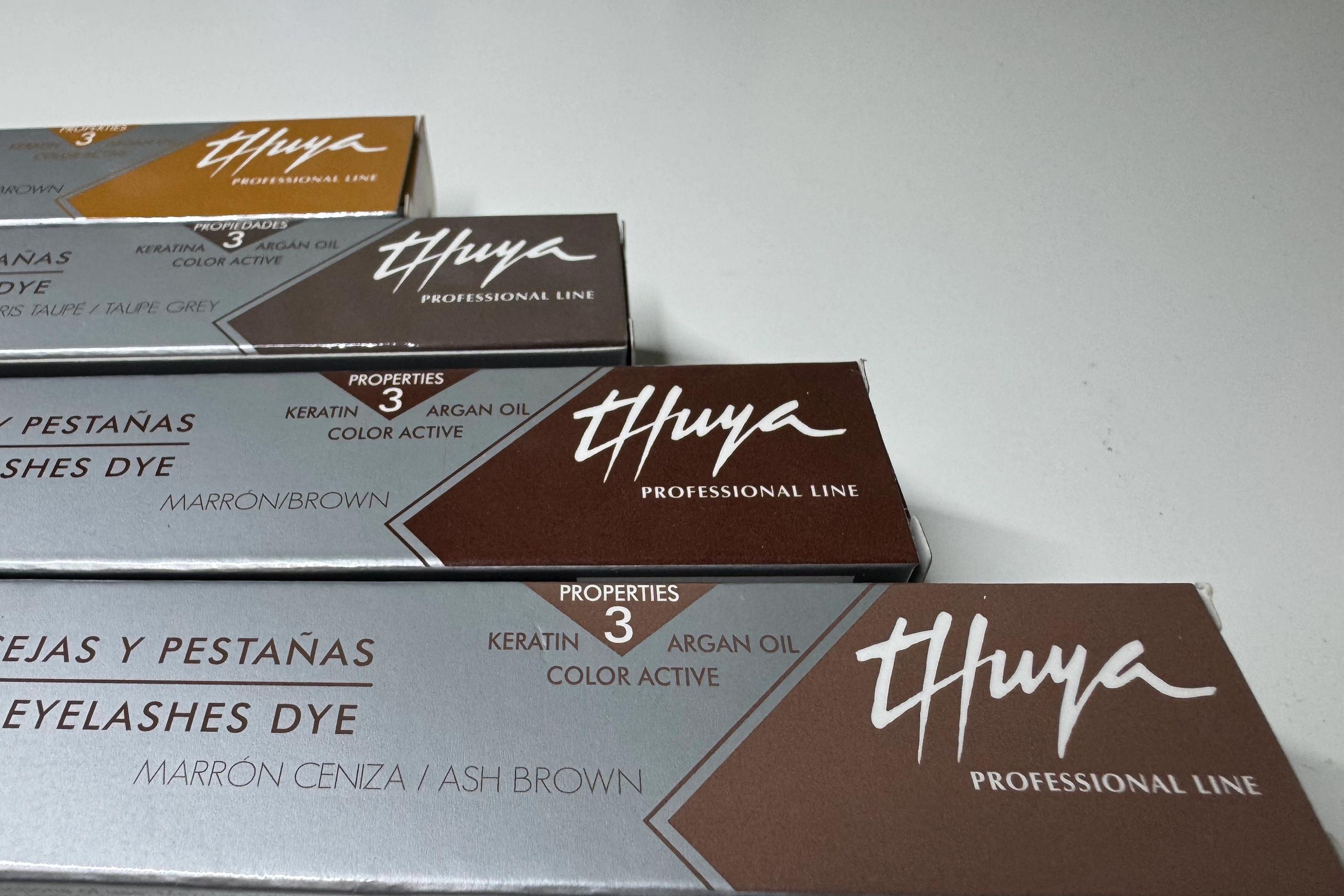Thuya eyebrow and eyelash tint boxes in several brown and taupe shades.