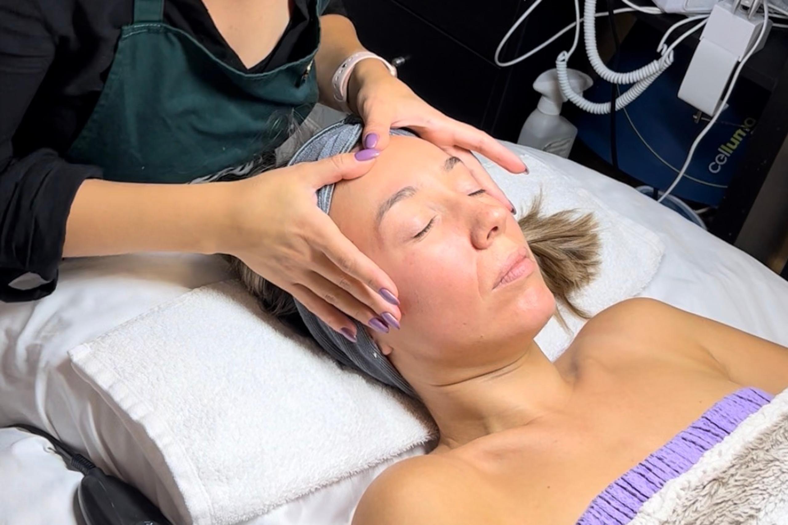 A client receives a facial massage from an esthetician.