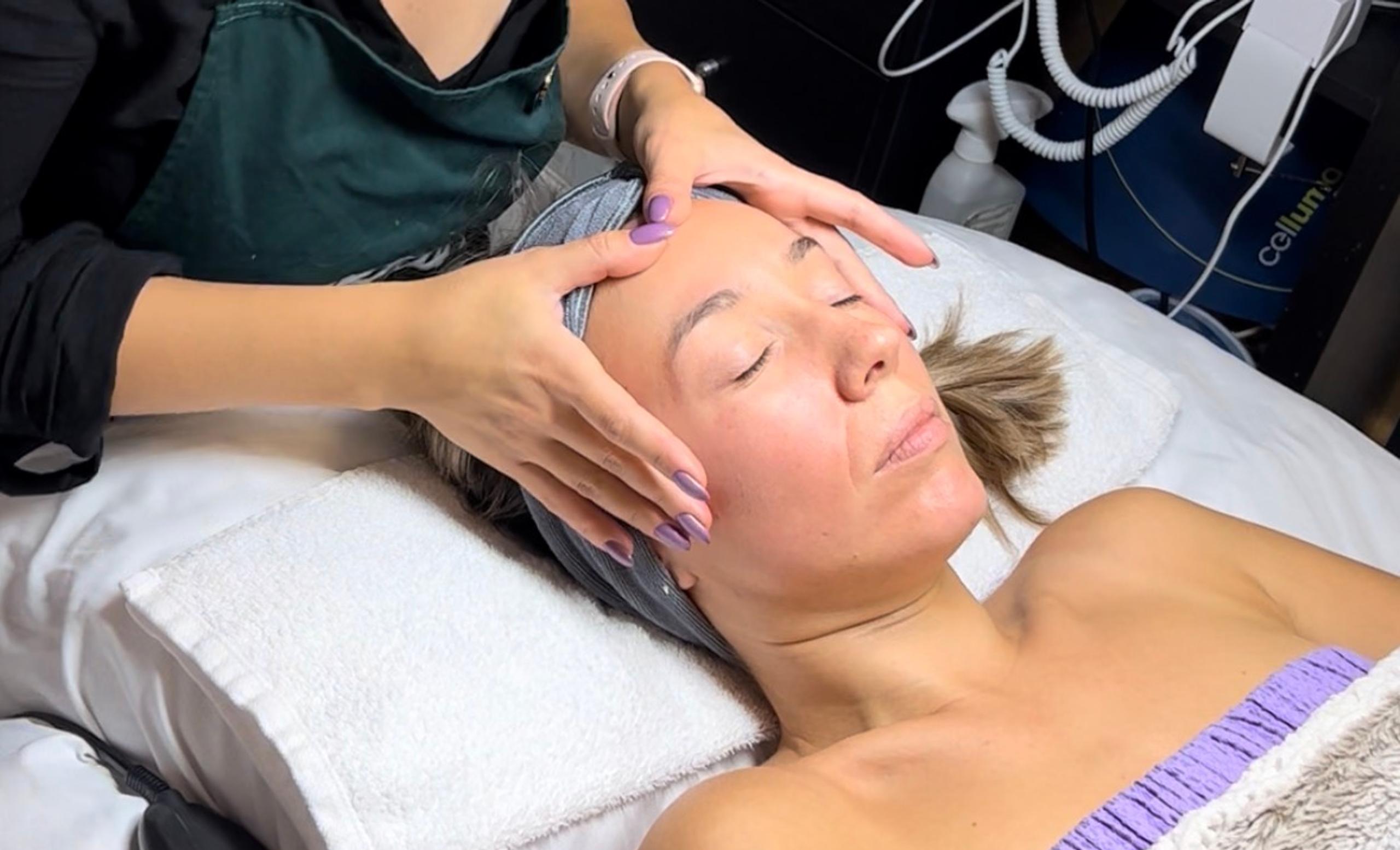 A client receives a facial massage from an esthetician.