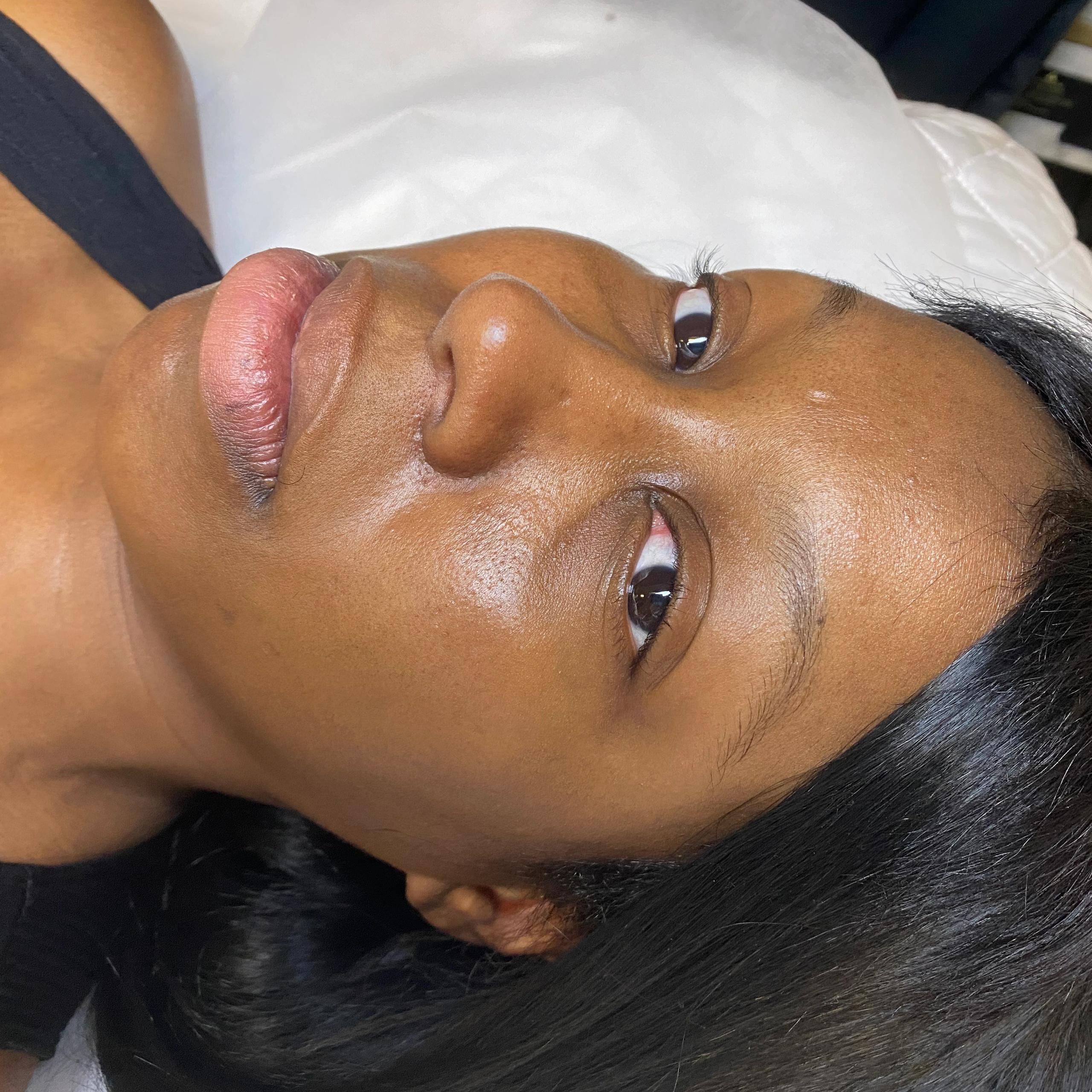 Close-up of a person lying down with full lips and dark hair.