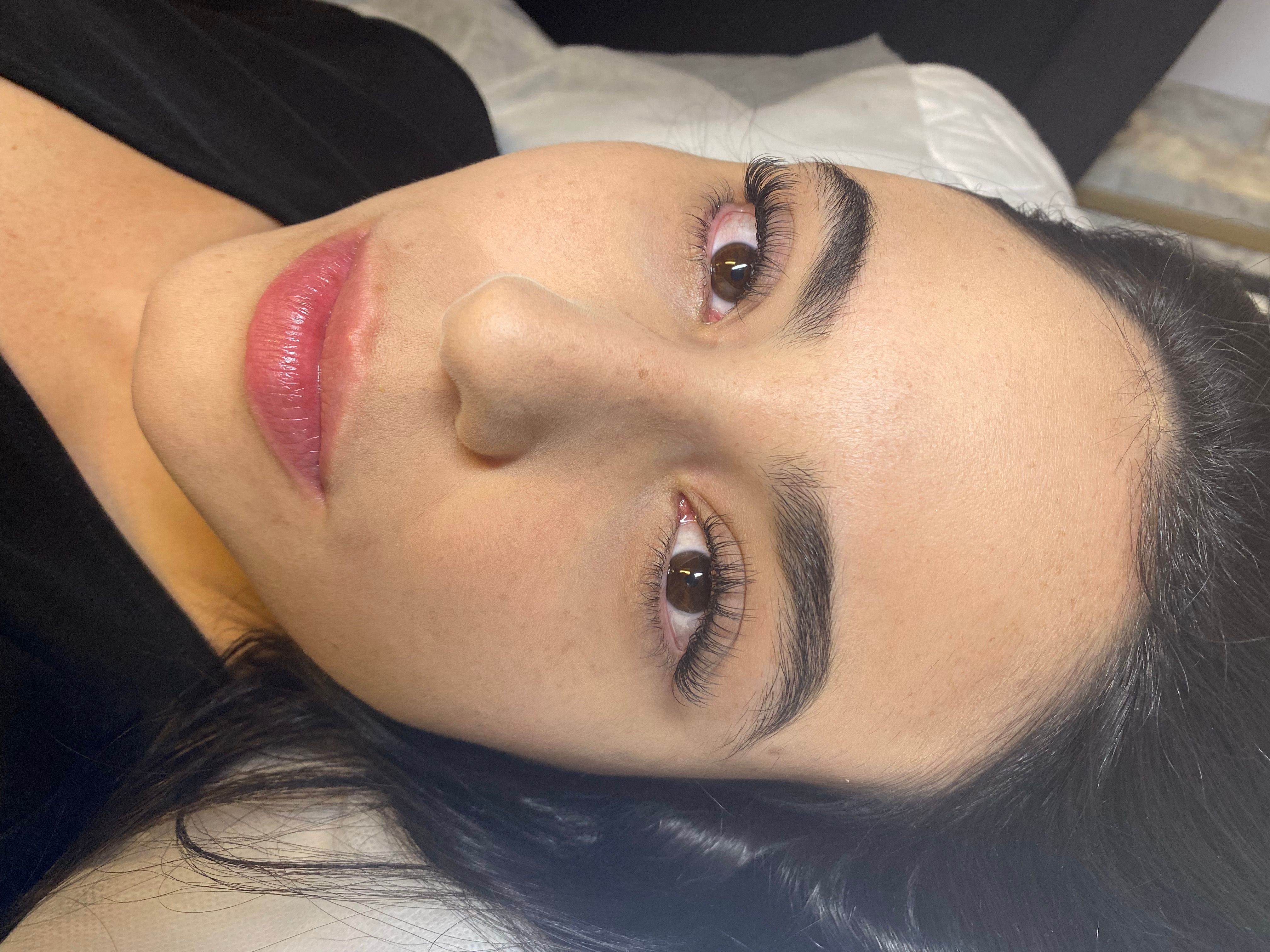 Reclining client with subtly lengthened, separated eyelash extensions