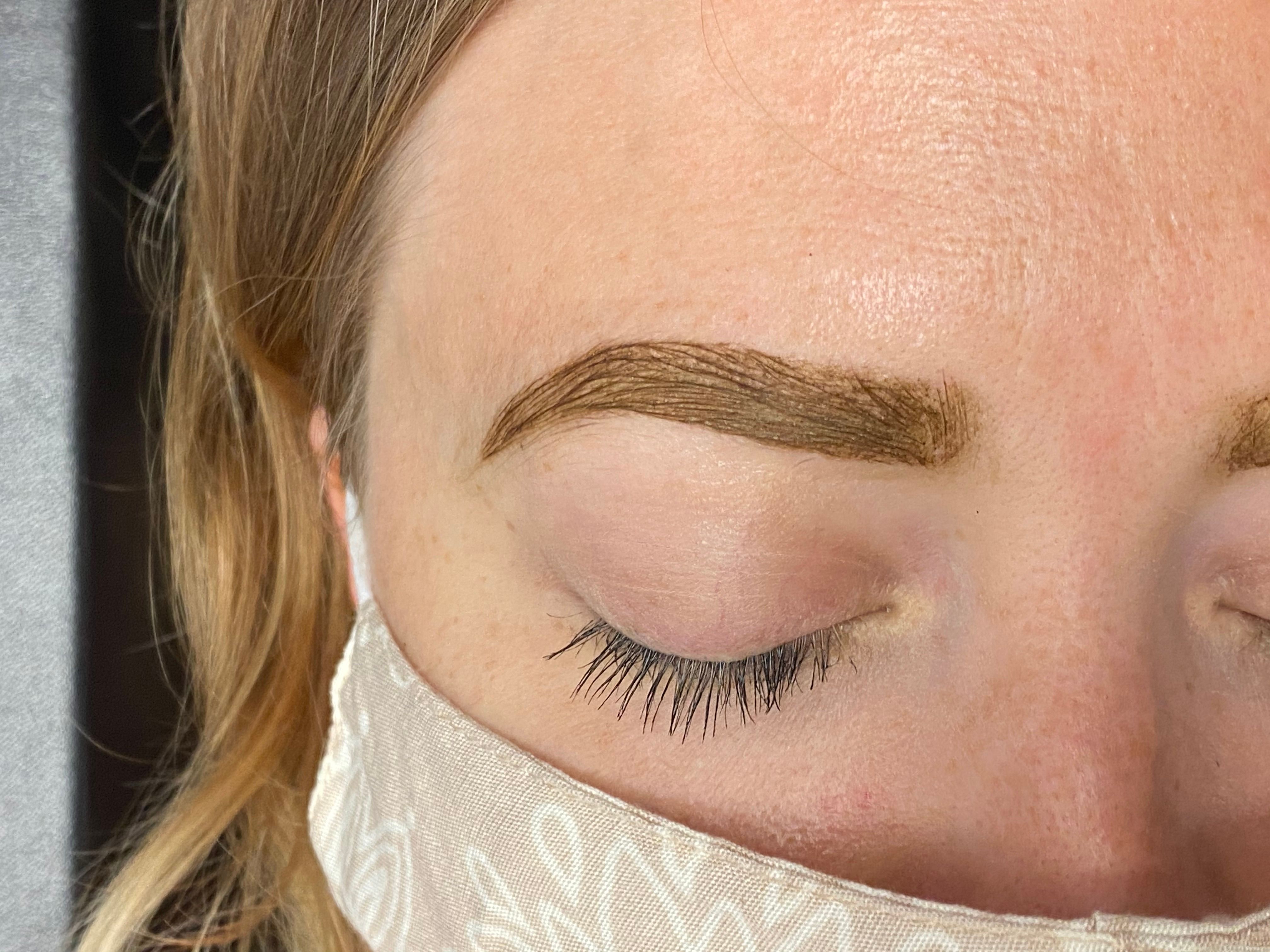 Fresh brown tint coats and defines a client's eyebrow.