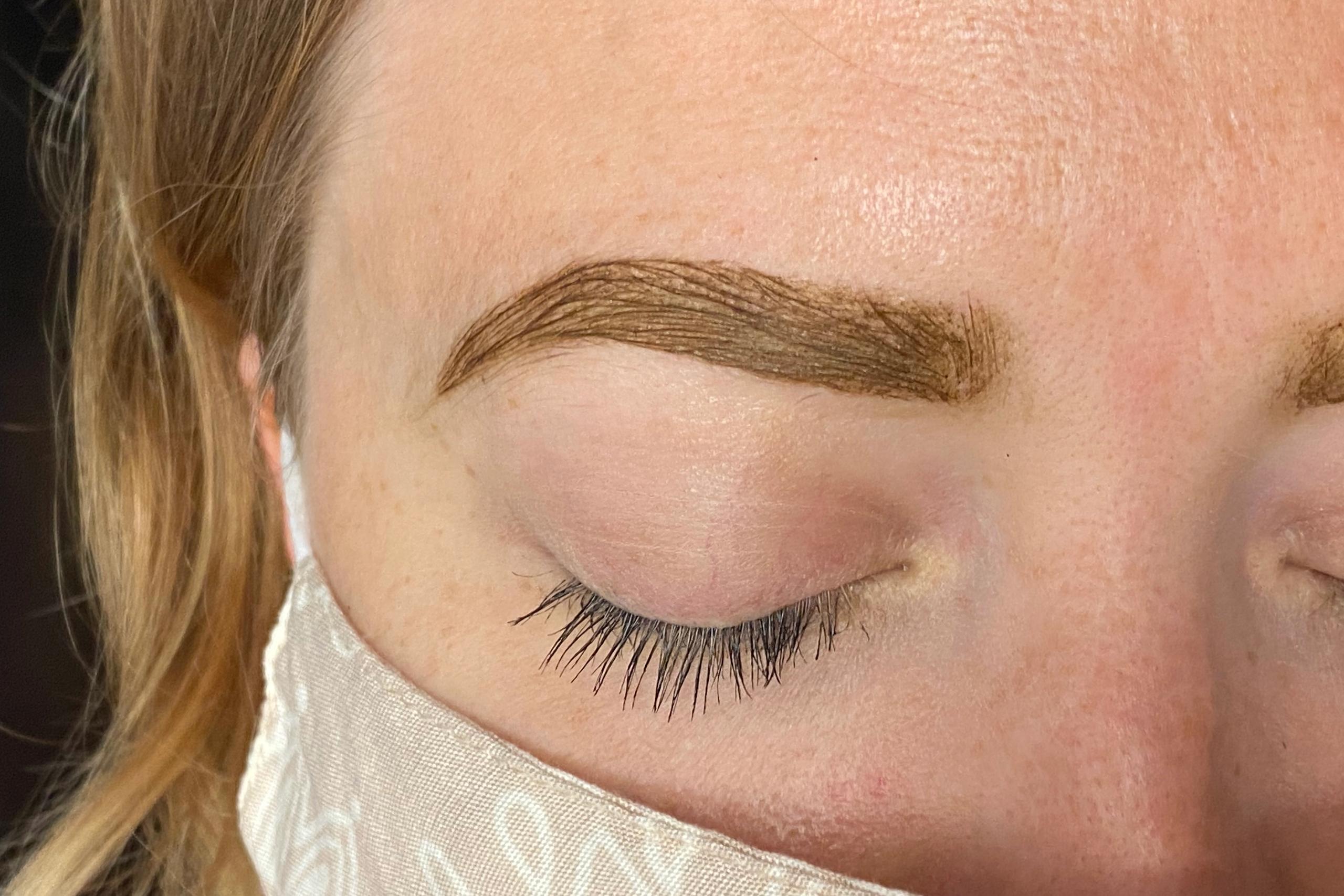 Fresh brown tint coats and defines a client's eyebrow.