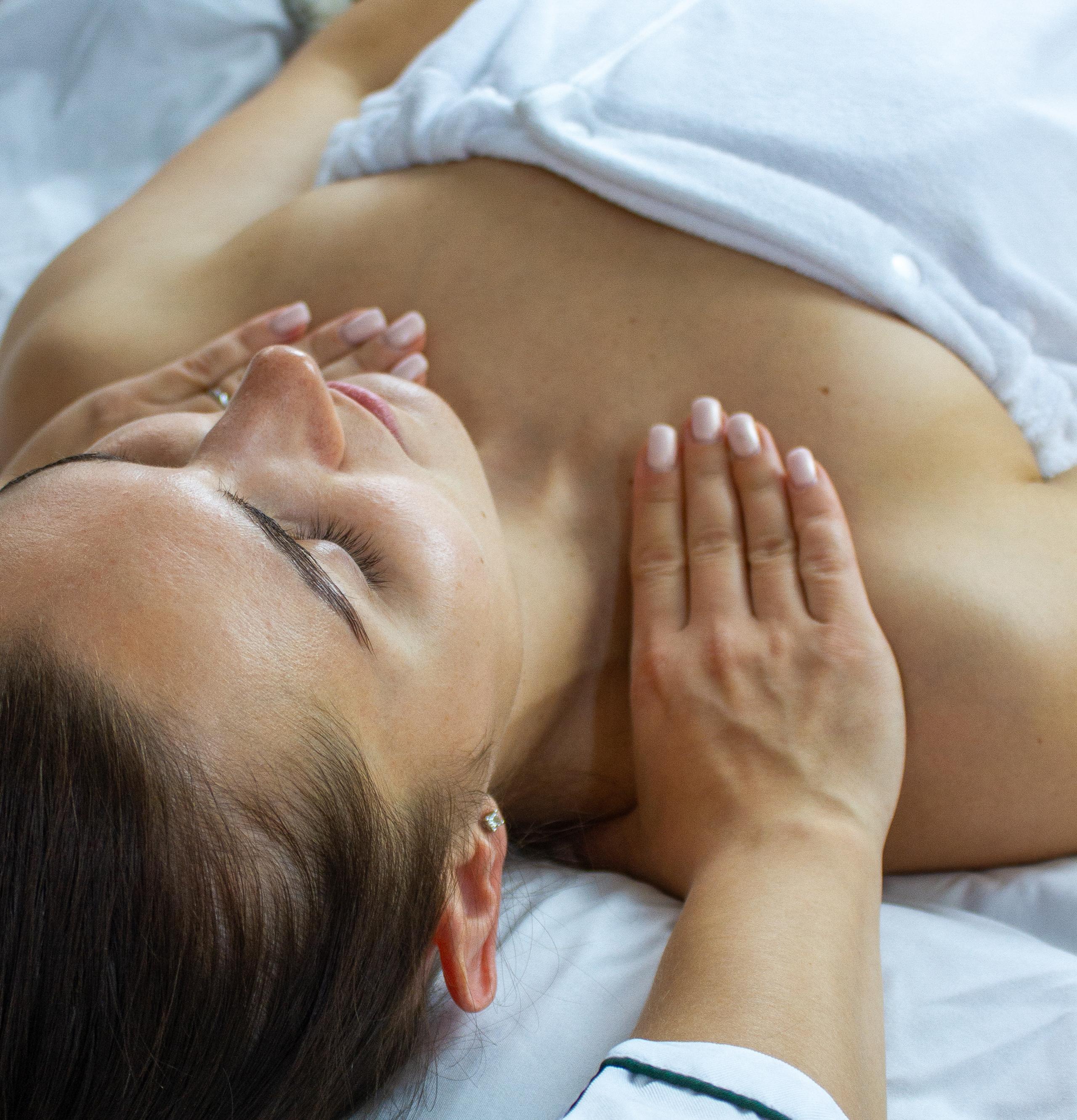 Relaxed woman receiving a chest massage.