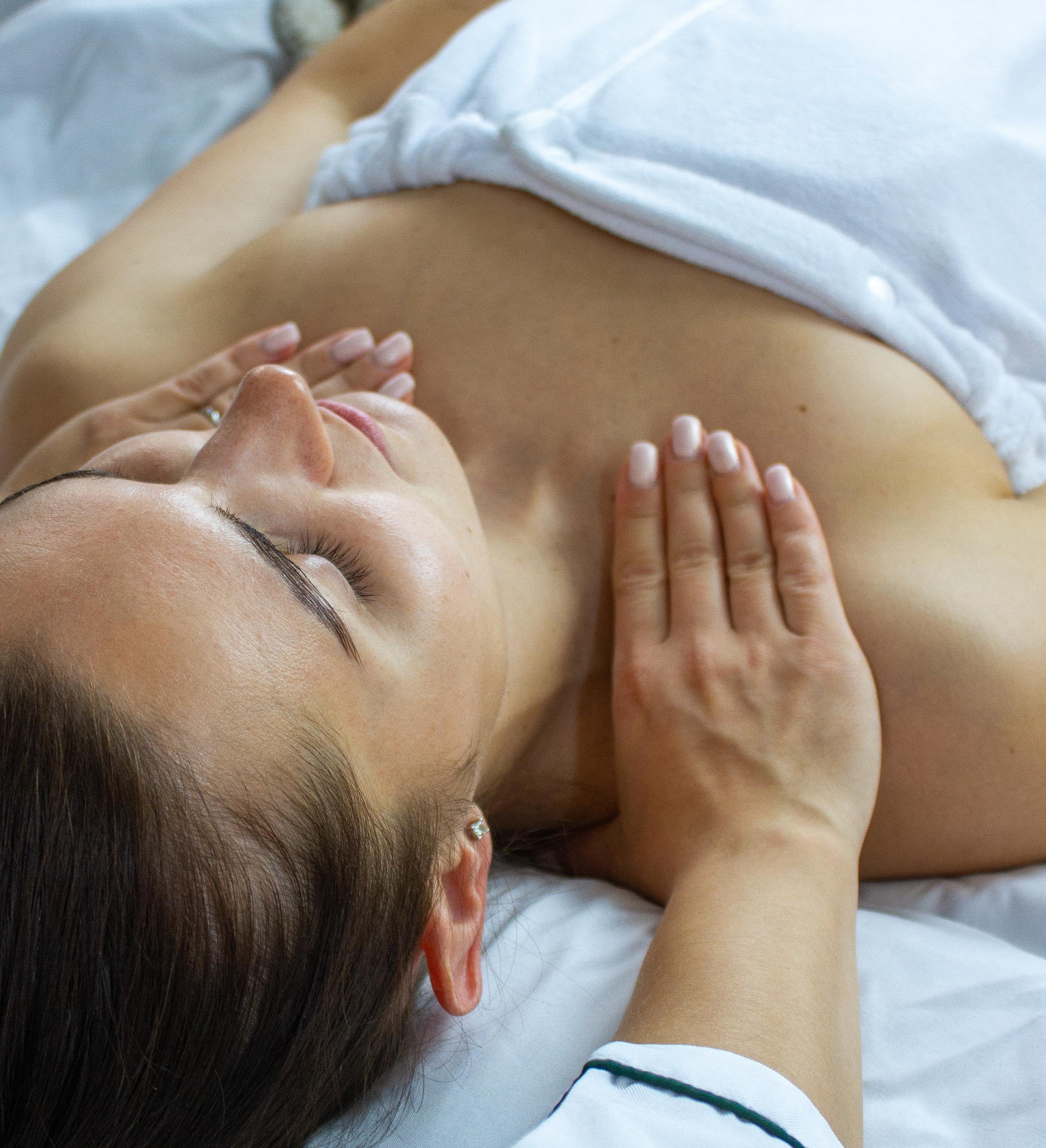 Relaxed woman receiving a chest massage.