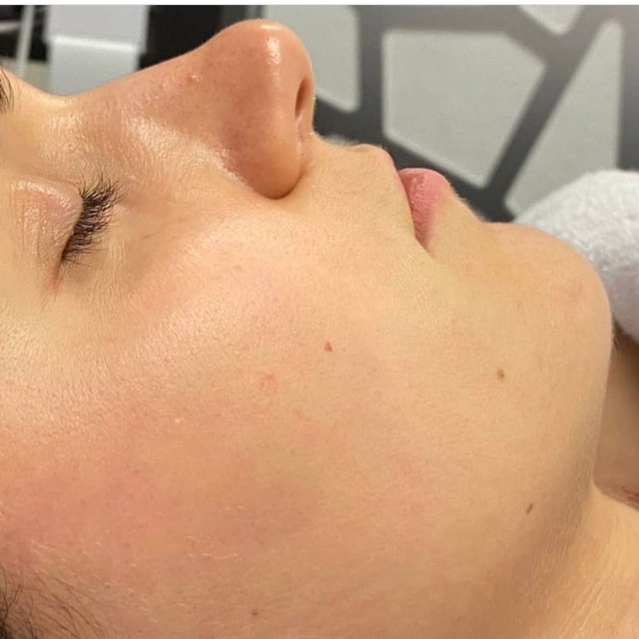 Profile view of a person with closed eyes, showing clean skin