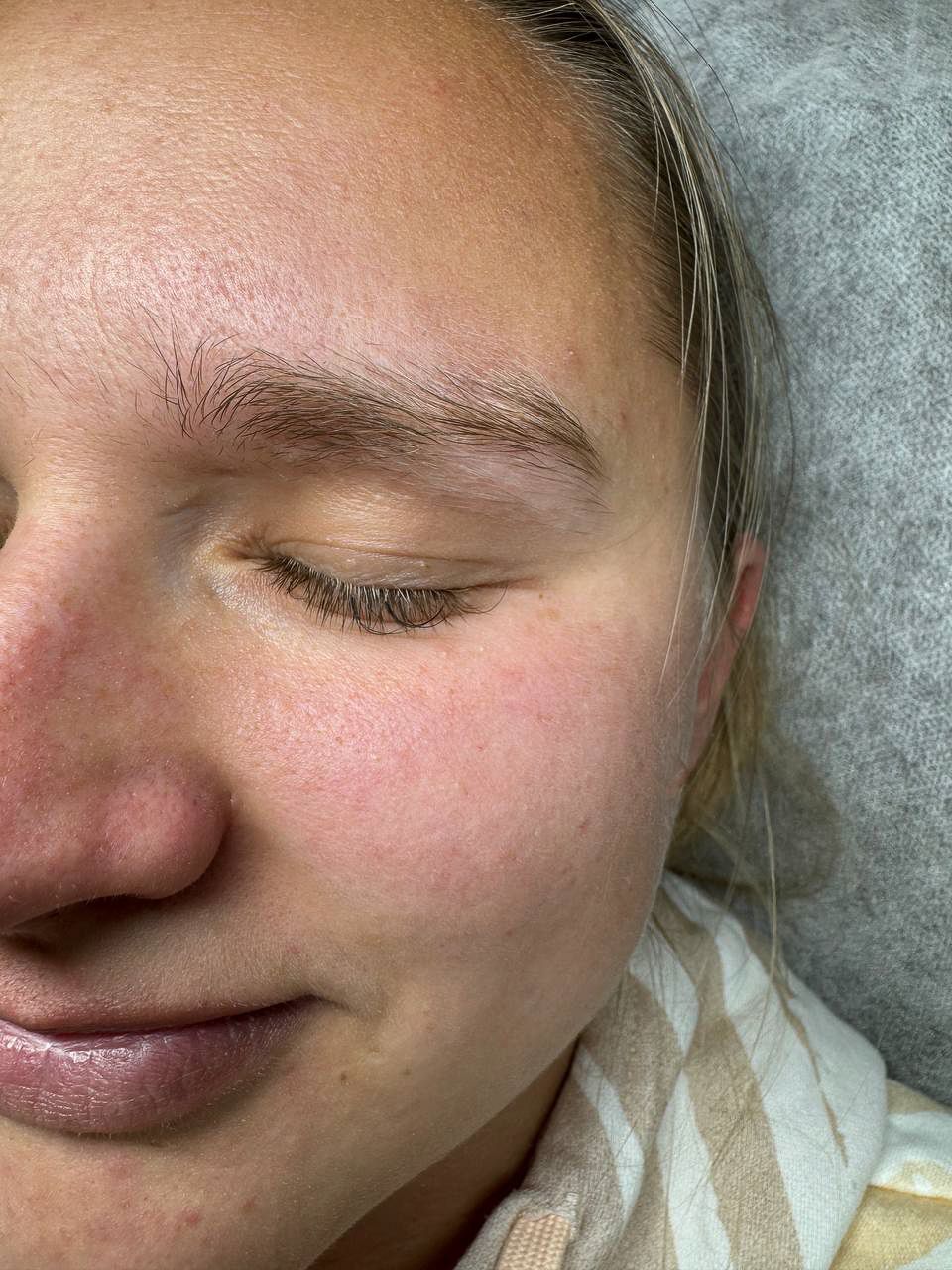 Before brow tinting: a client's natural blonde eyebrow with lighter, sparse hairs.