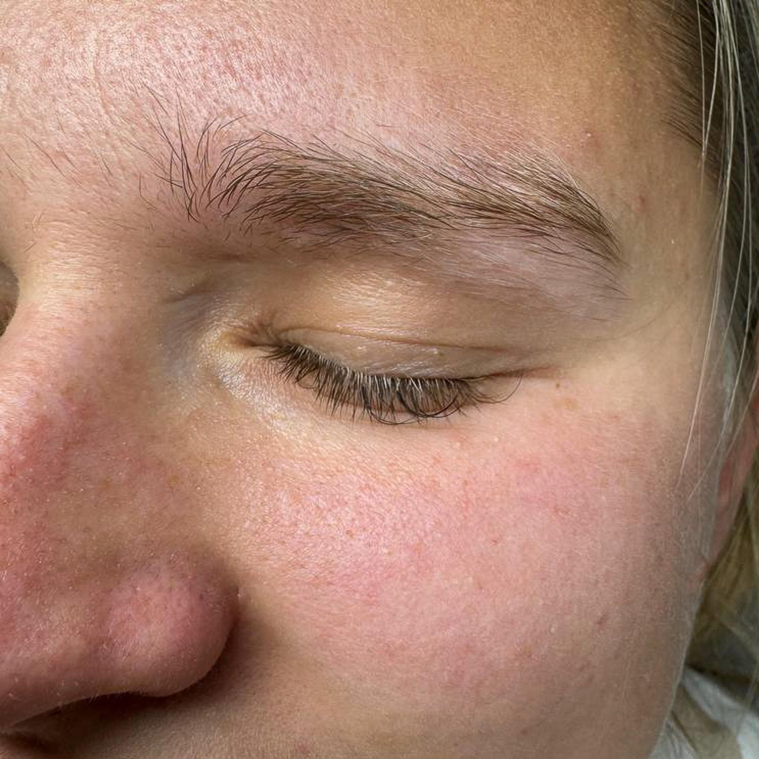 Before brow tinting: a client's natural blonde eyebrow with lighter, sparse hairs.