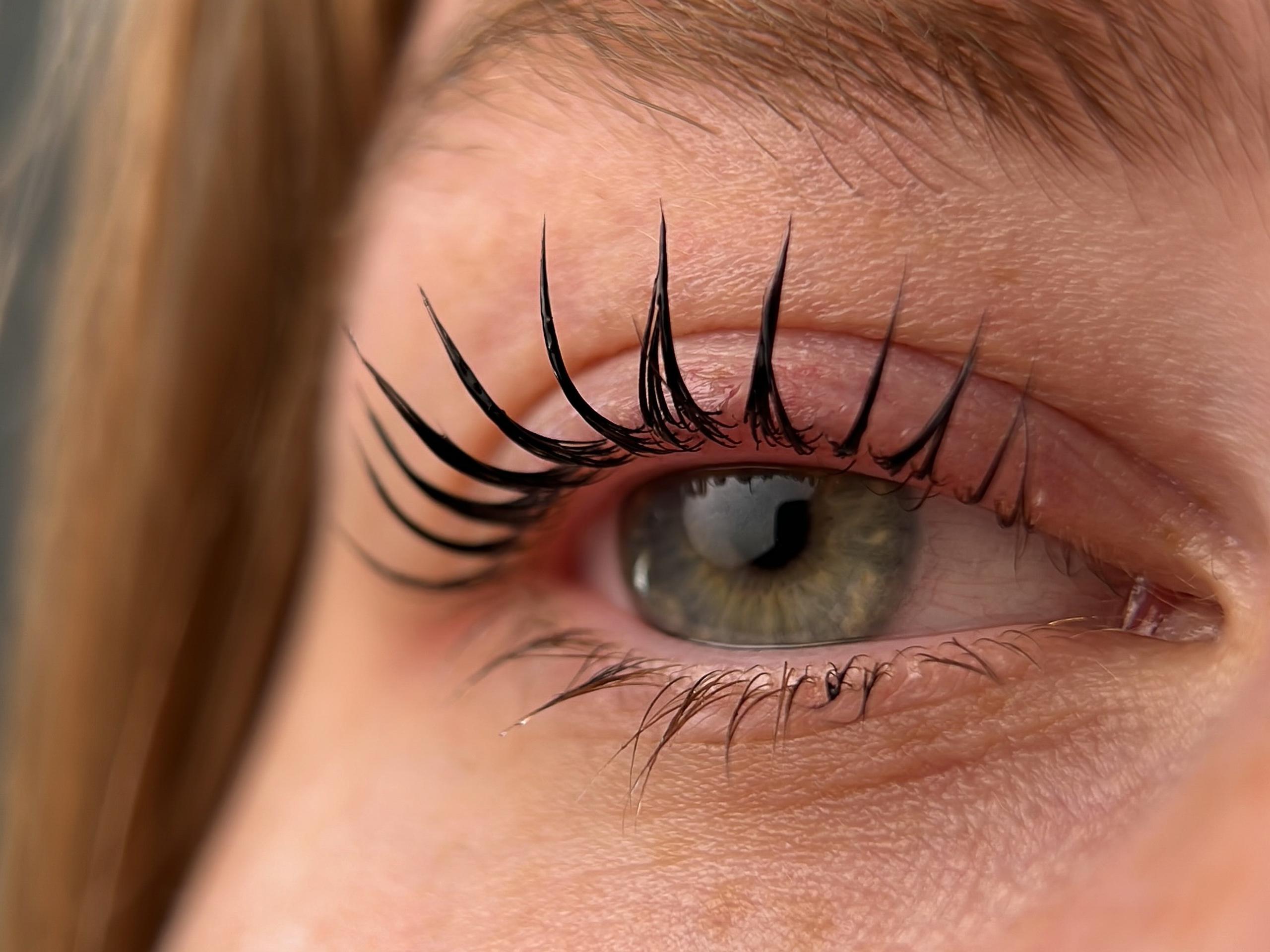 A close-up of an open eye with lifted and tinted lashes