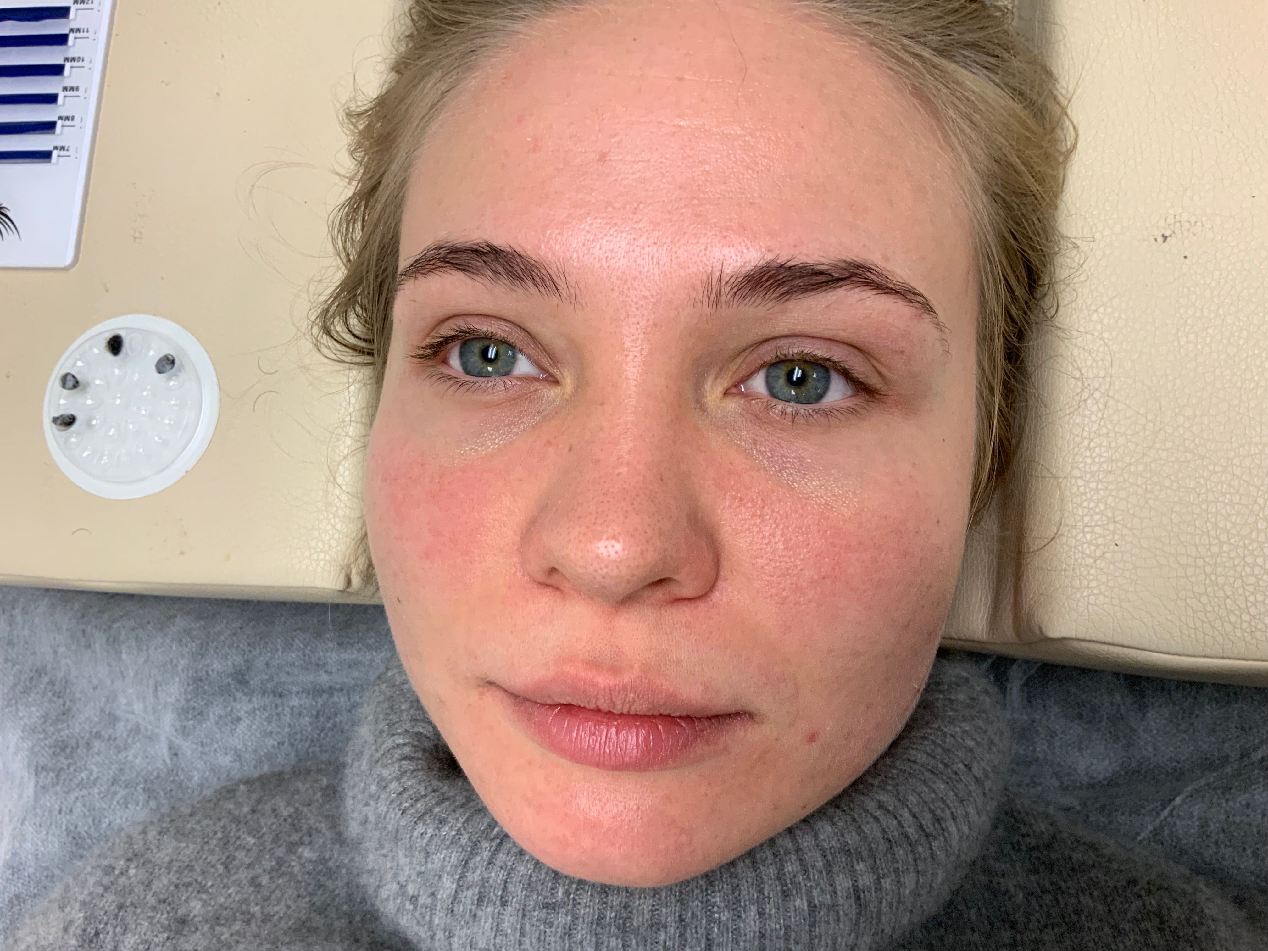 Close-up of a woman's face with blue eyes, lying down
