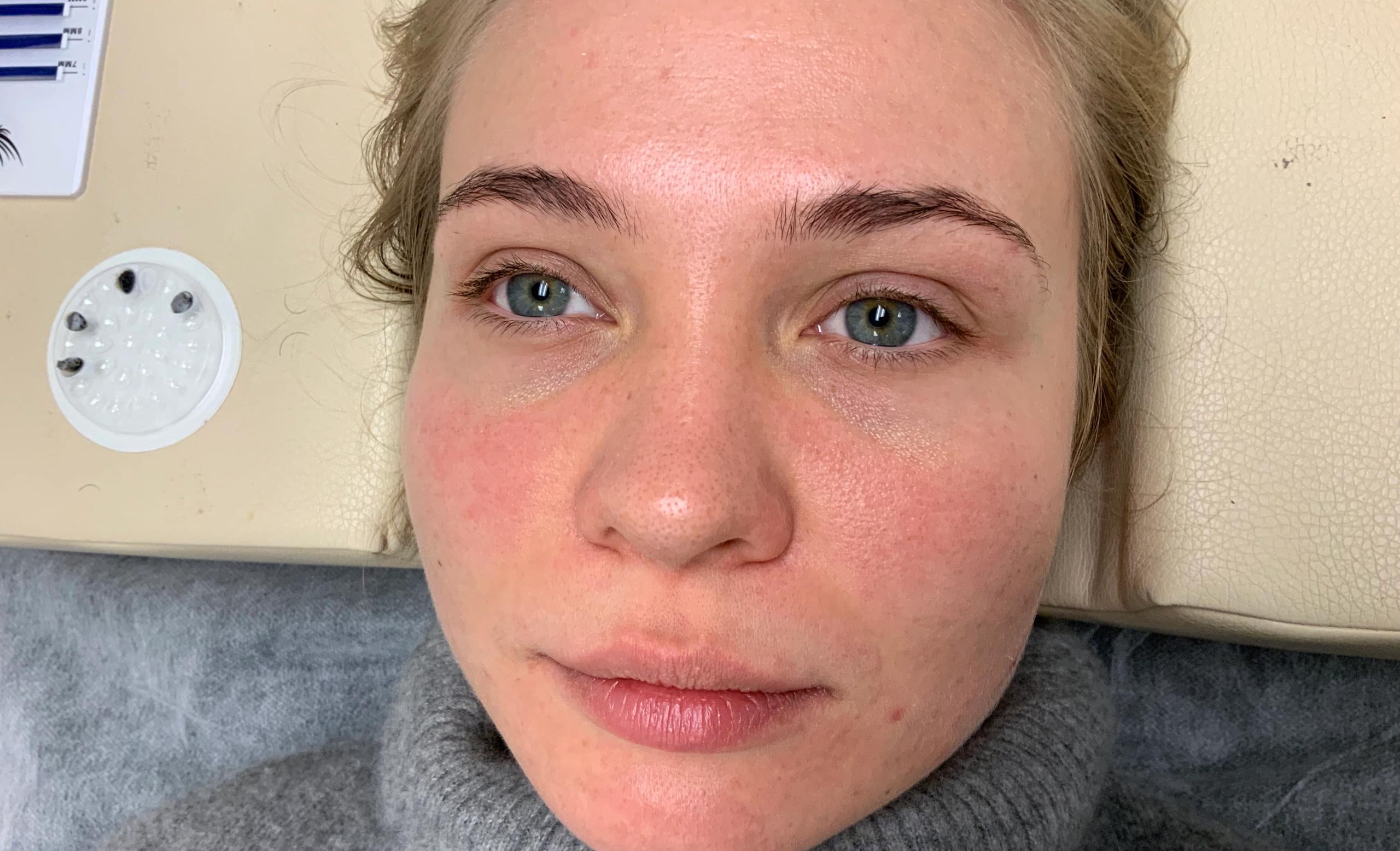 Close-up of a woman's face with blue eyes, lying down