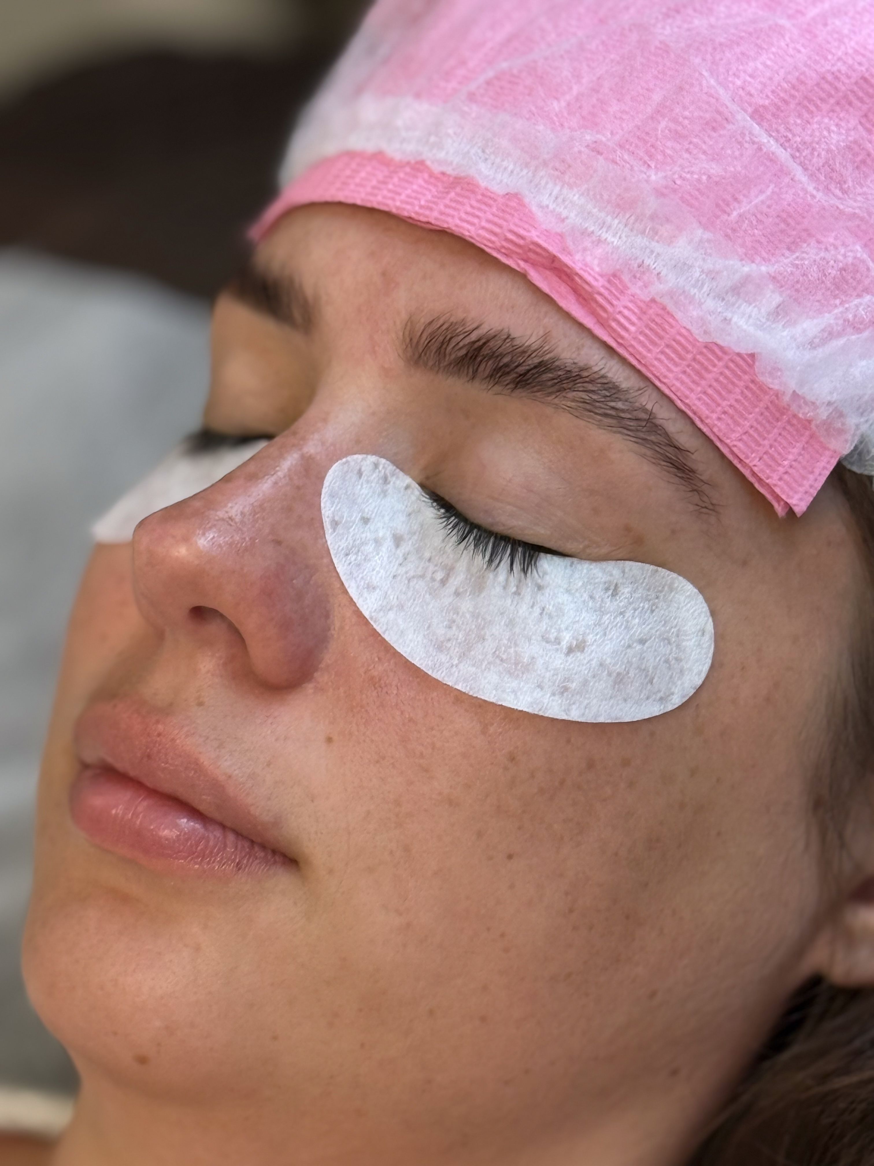 Client resting with eyes closed and under-eye pads during a lash appointment at Beauty Republic.