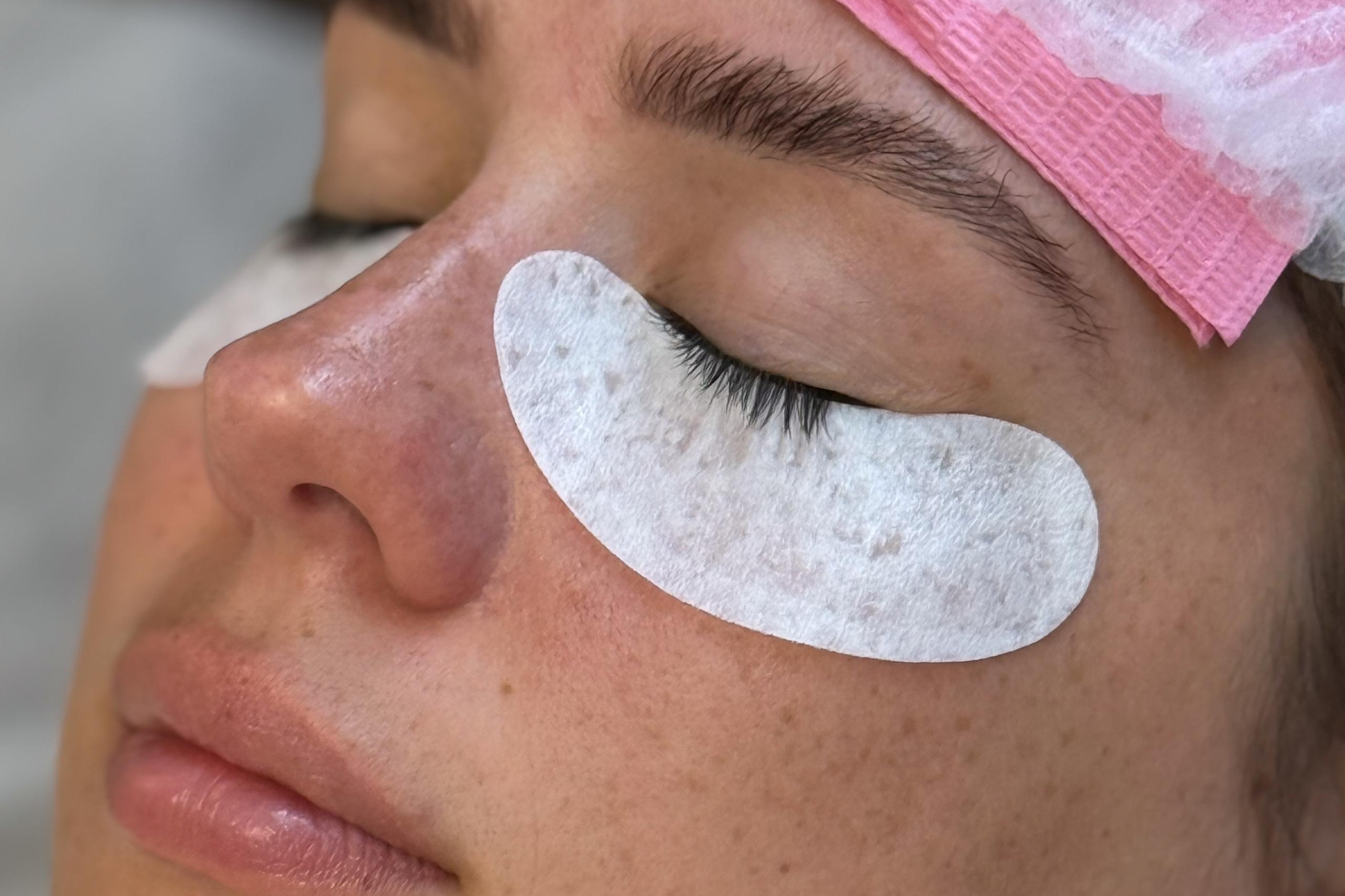 Client resting with eyes closed and under-eye pads during a lash appointment at Beauty Republic.