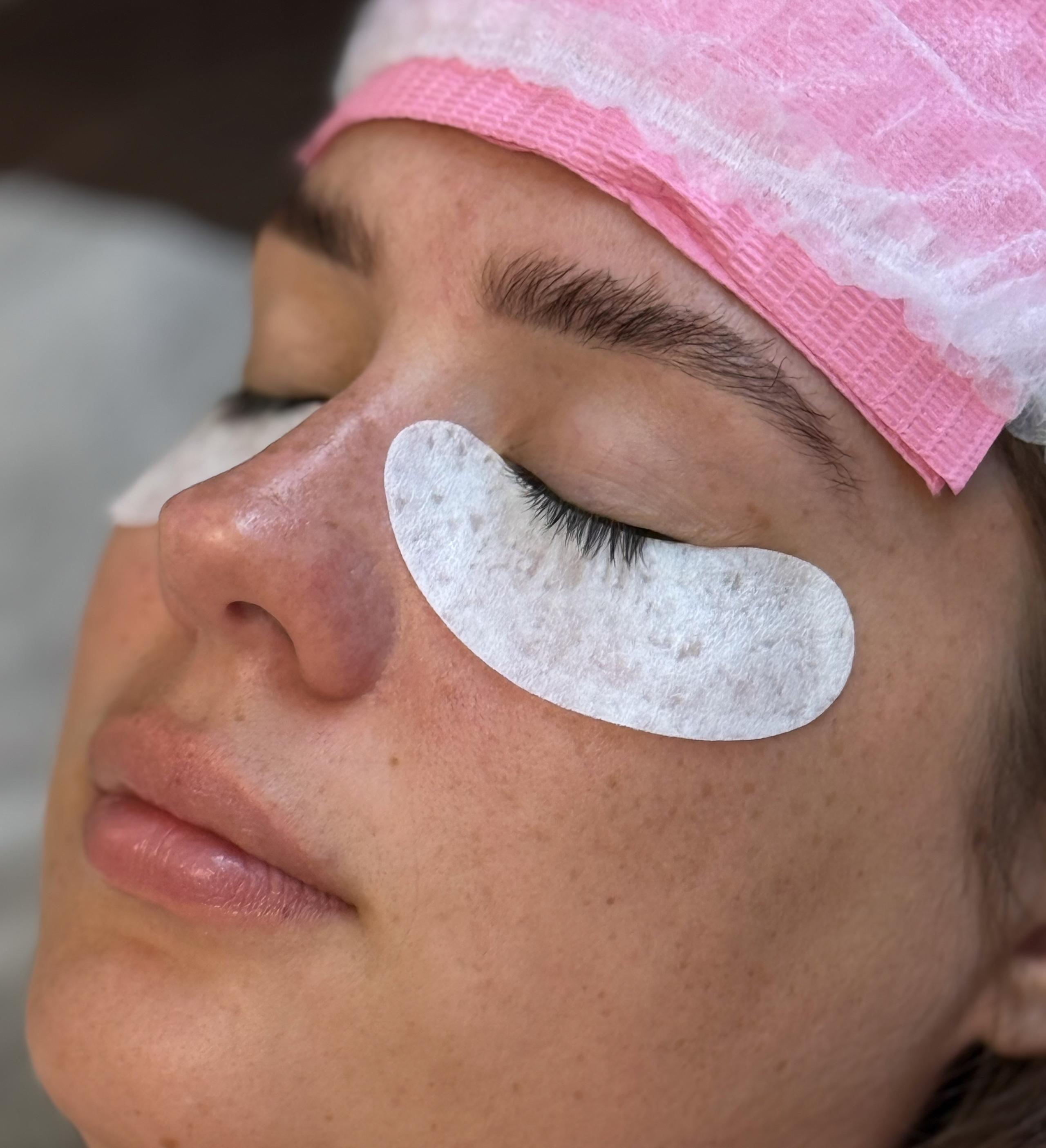 Client resting with eyes closed and under-eye pads during a lash appointment at Beauty Republic.
