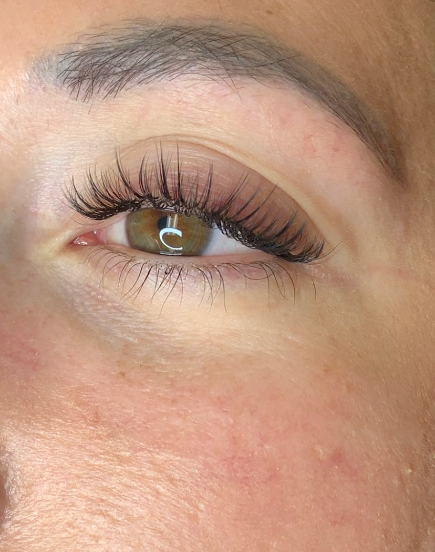 Hazel eye with wispy eyelash extensions and longer, curled spikes
