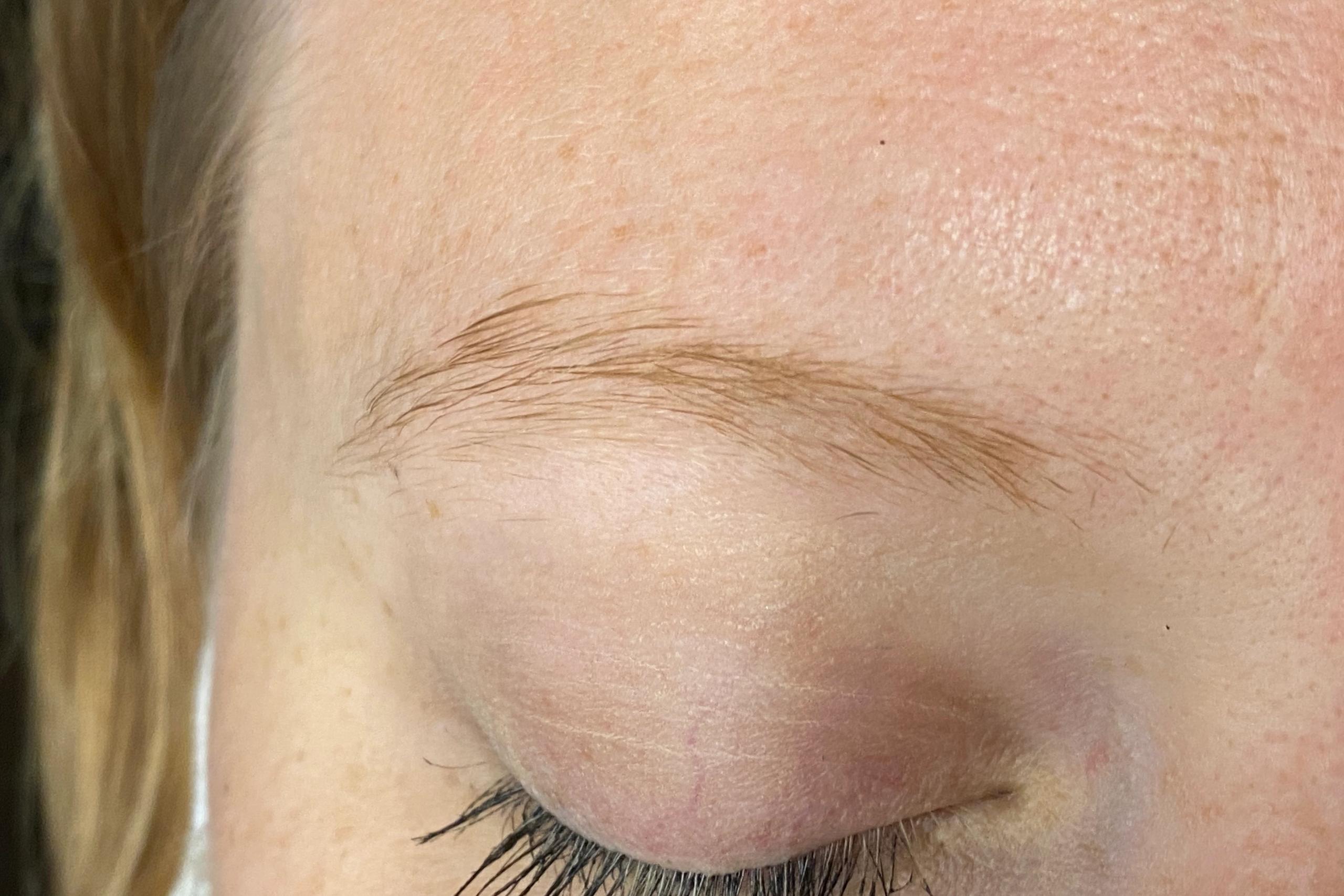 Close-up of a client's light eyebrow before tint is applied.