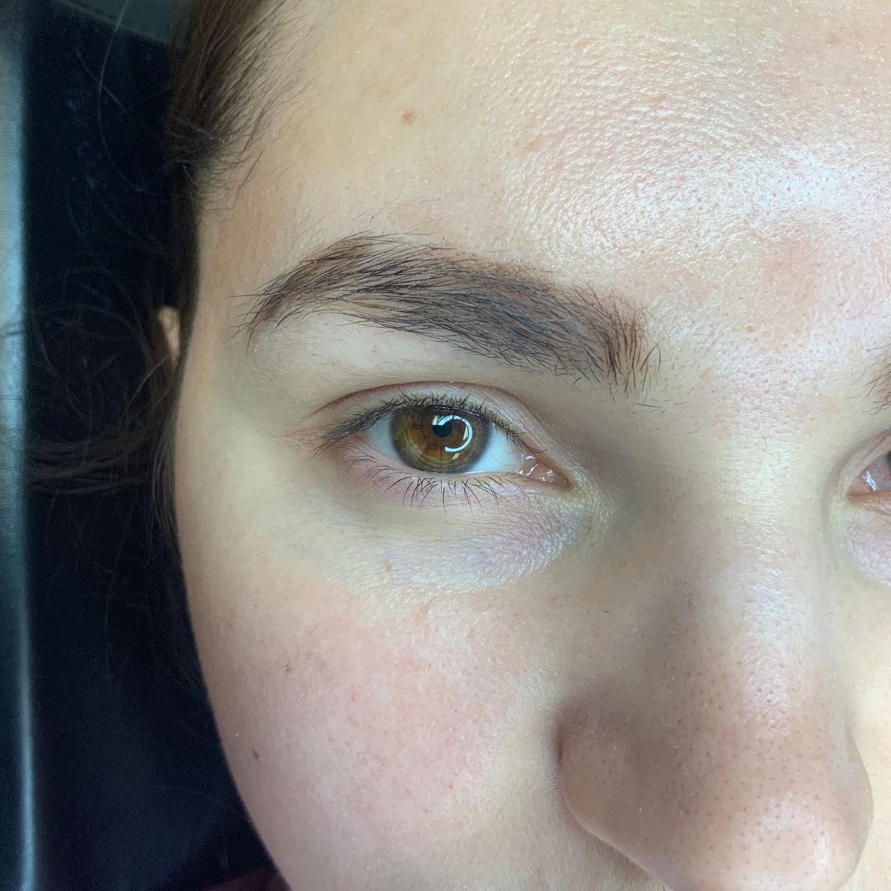 Close-up of a person's right eye and full eyebrow.