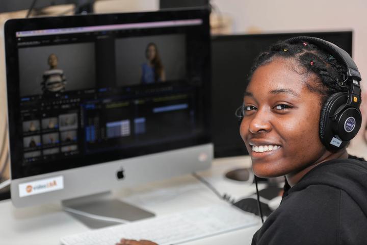 Teen videographer editing video for website publication