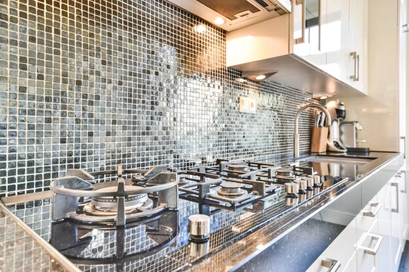 Home kitchen remodel with custom tile flooring and backsplash installation in Cottage Grove