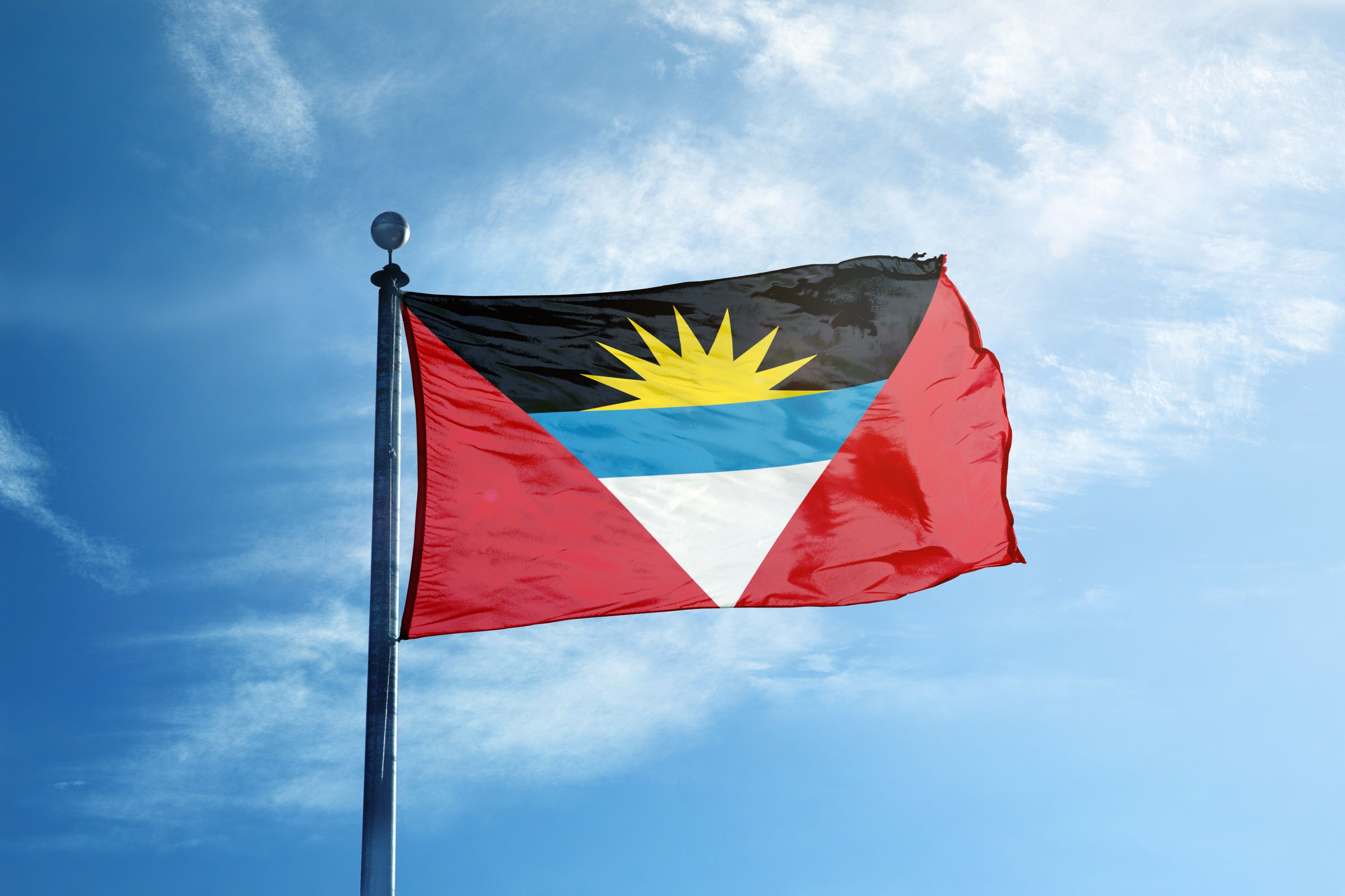 Antigua & Barbuda Flag with a sky in the background