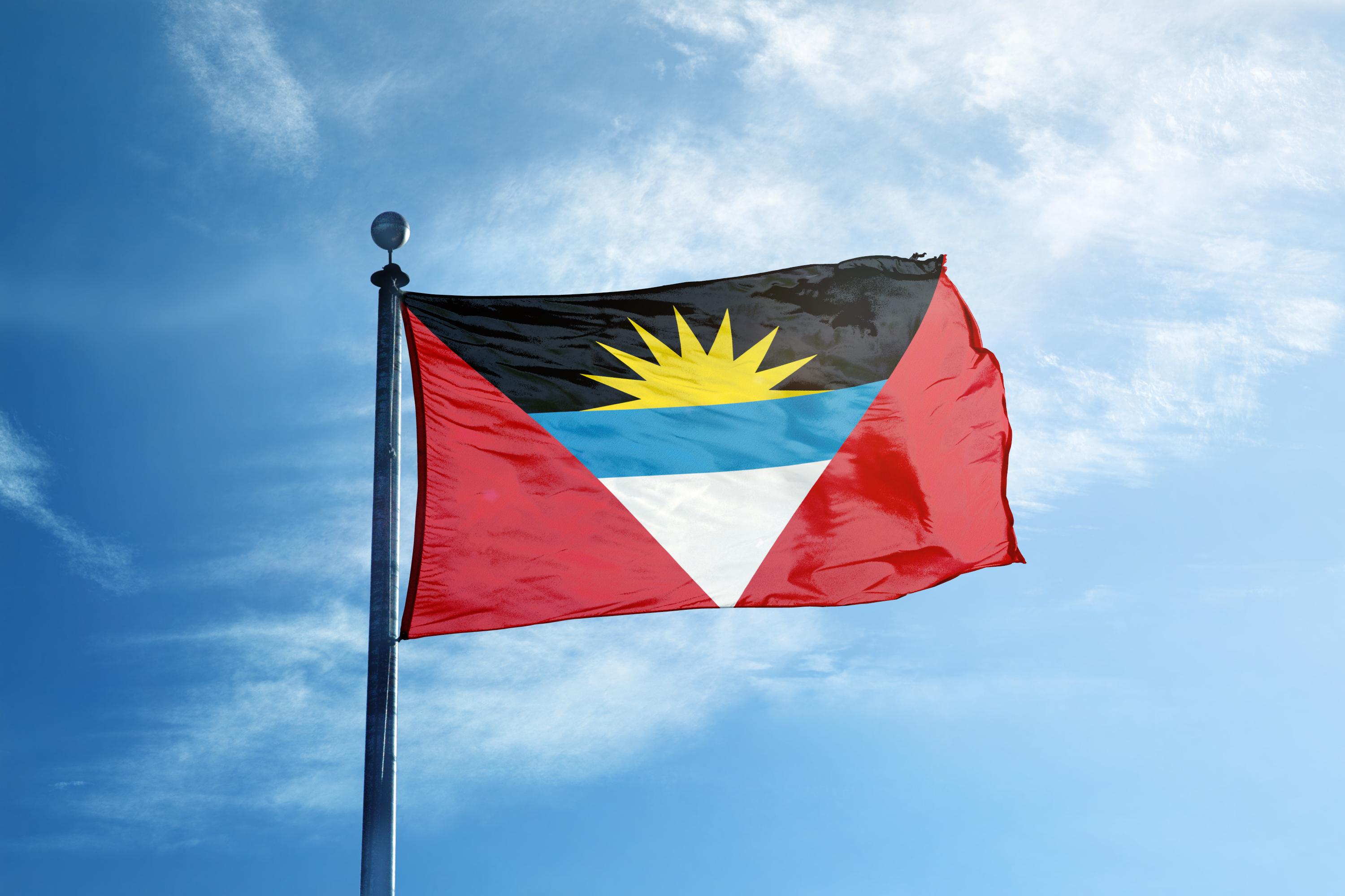 Antigua & Barbuda Citizenship by Investment Routes Antigua & Barbuda Flag with a sky in the background