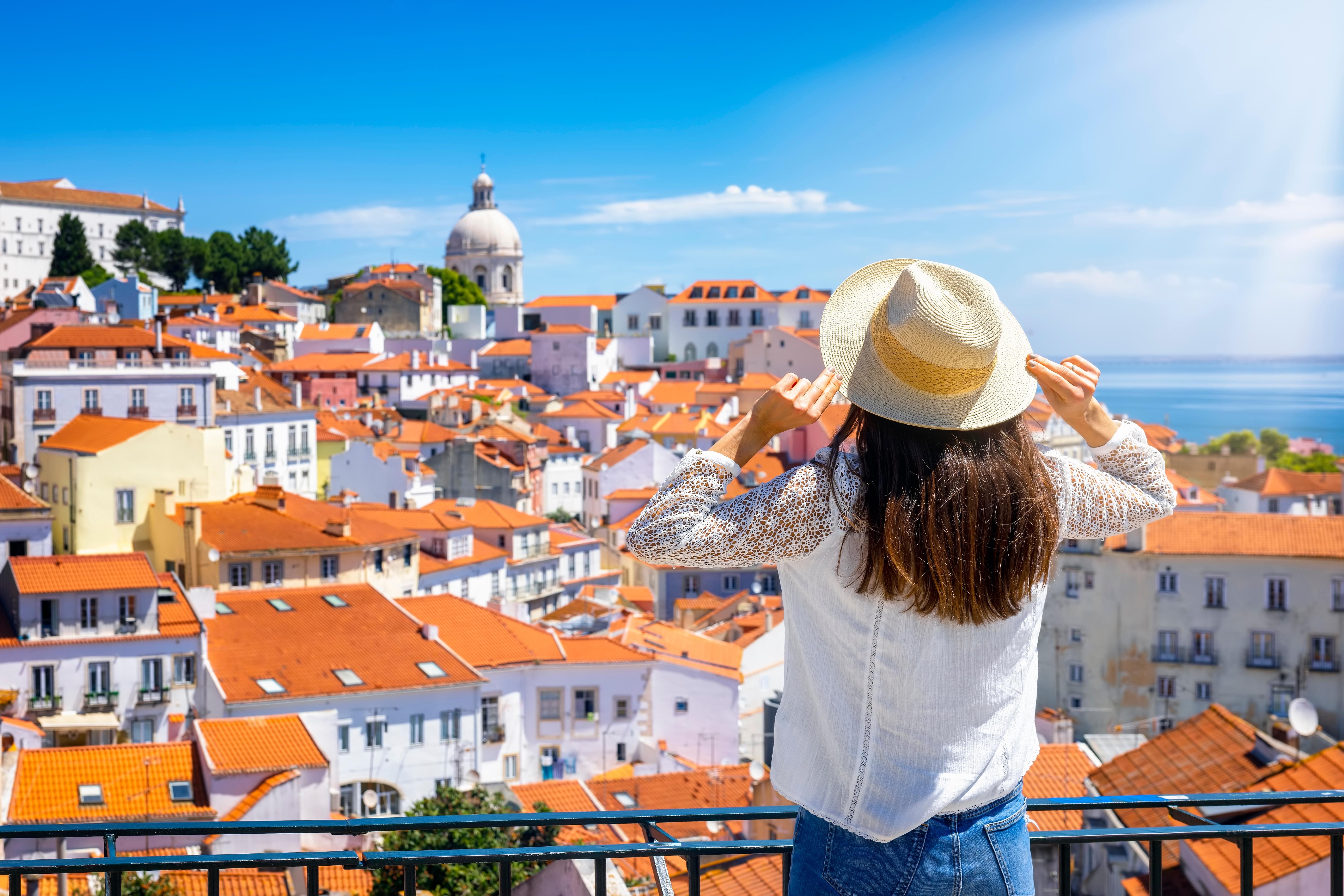 Portugal Digital Nomad Visa: Why You Should Consider It Back of a Woman wearing hat watching