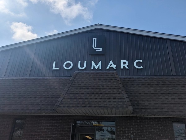 Photo of the new Loumarc Signs logo and sign on the front of the Loumarc Signs building!