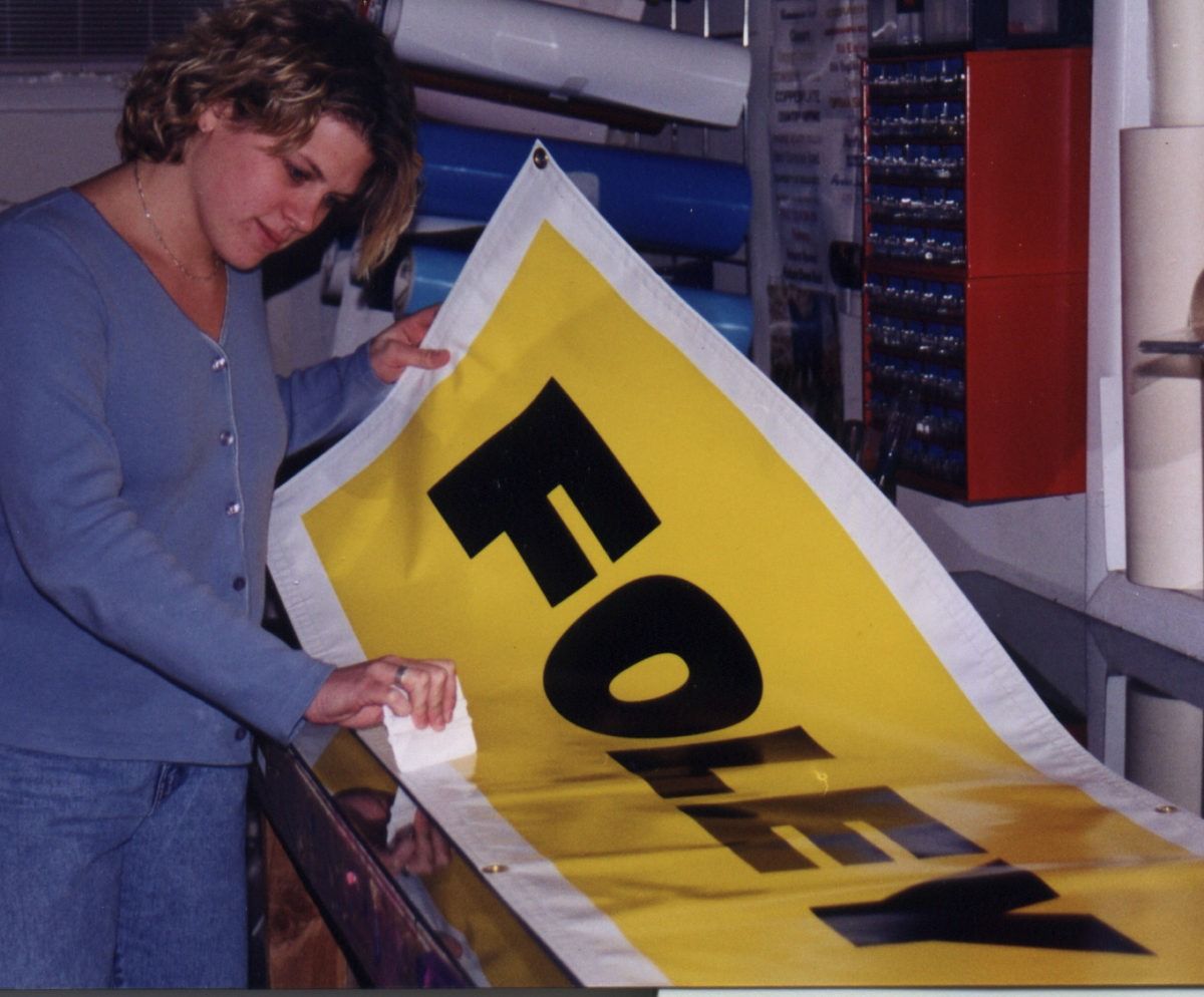 Teri finishing a banner for Foley — New Jersey customer banner sign company