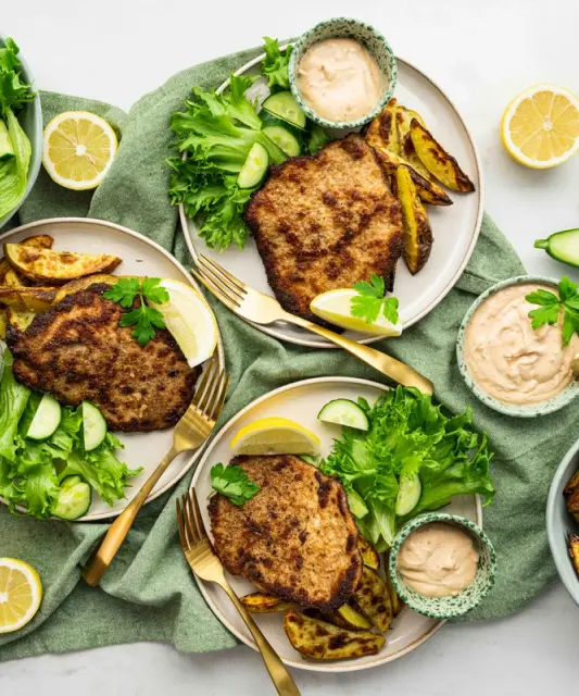 Panko-crumbed pork steaks, potato wedges & salad