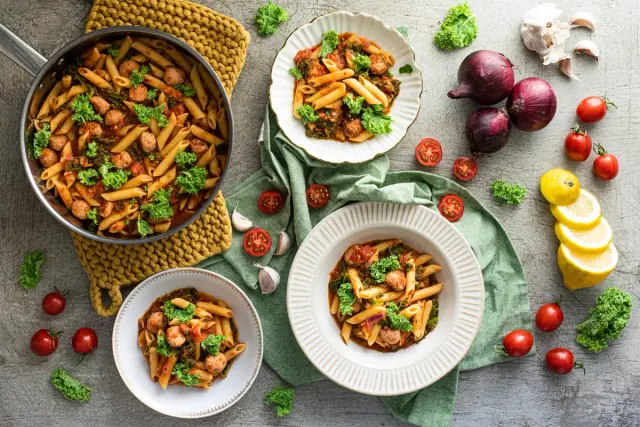 Penne in a Delicate Tomato Sauce with Juicy Sausage and Kale