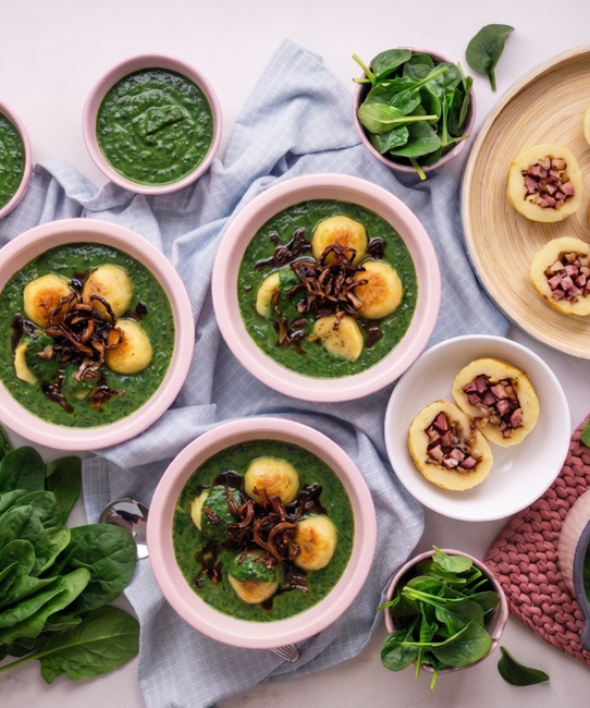 Farmhouse-Style Potato Dumplings Stuffed with Smoked Meat, Served with Fresh Spinach and Onion