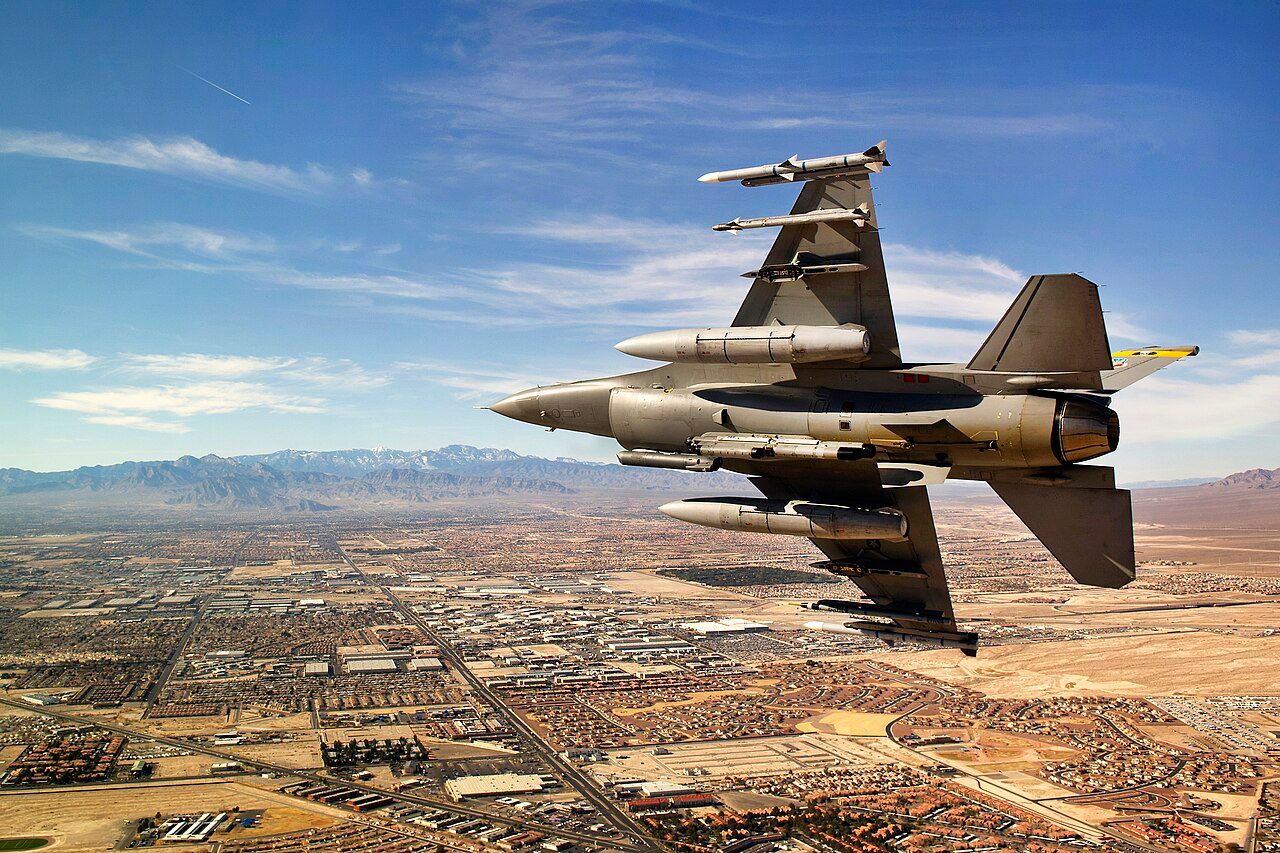 F16 Fighter Jet Turning Over Desert City