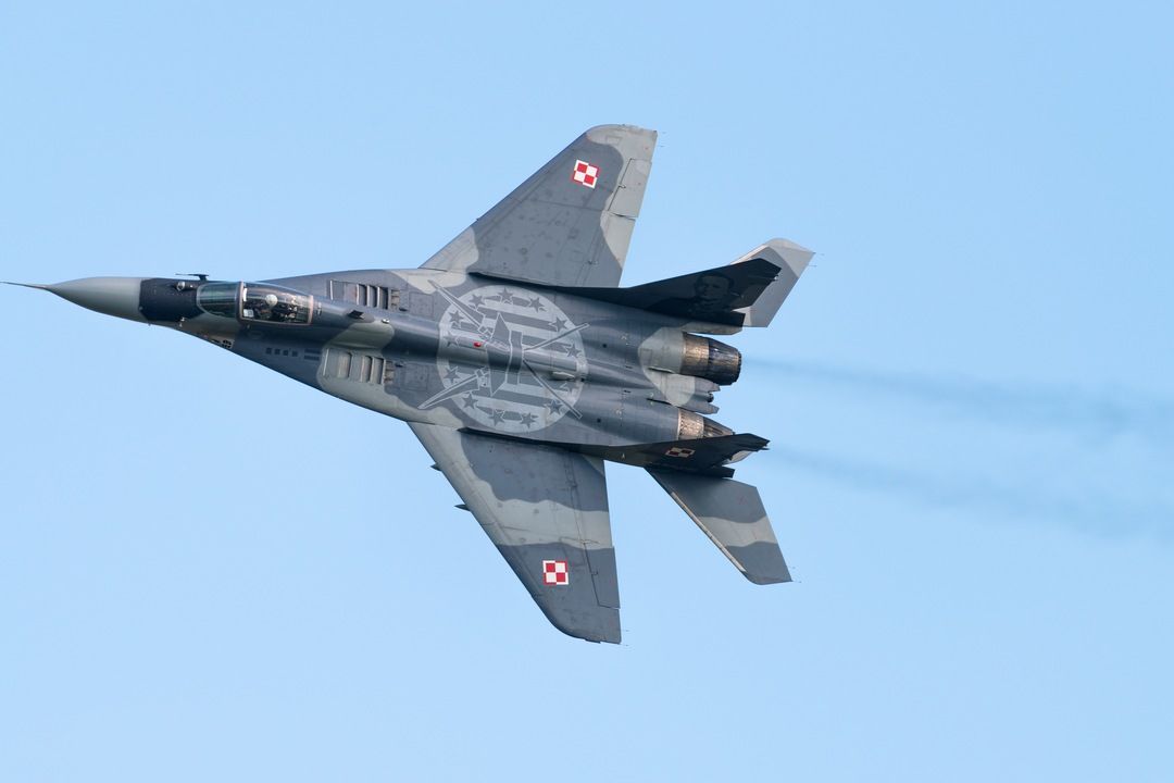 Polish Air Force MiG-29 fighter jet banking in flight against a clear sky