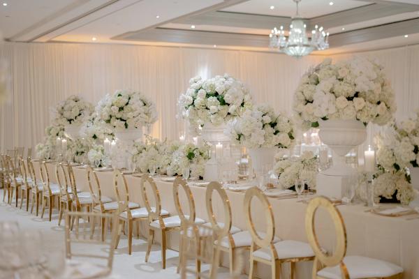 Ballroom reception at the Ritz-Carlton in Atlanta, long tables with tall white urn arrangements
