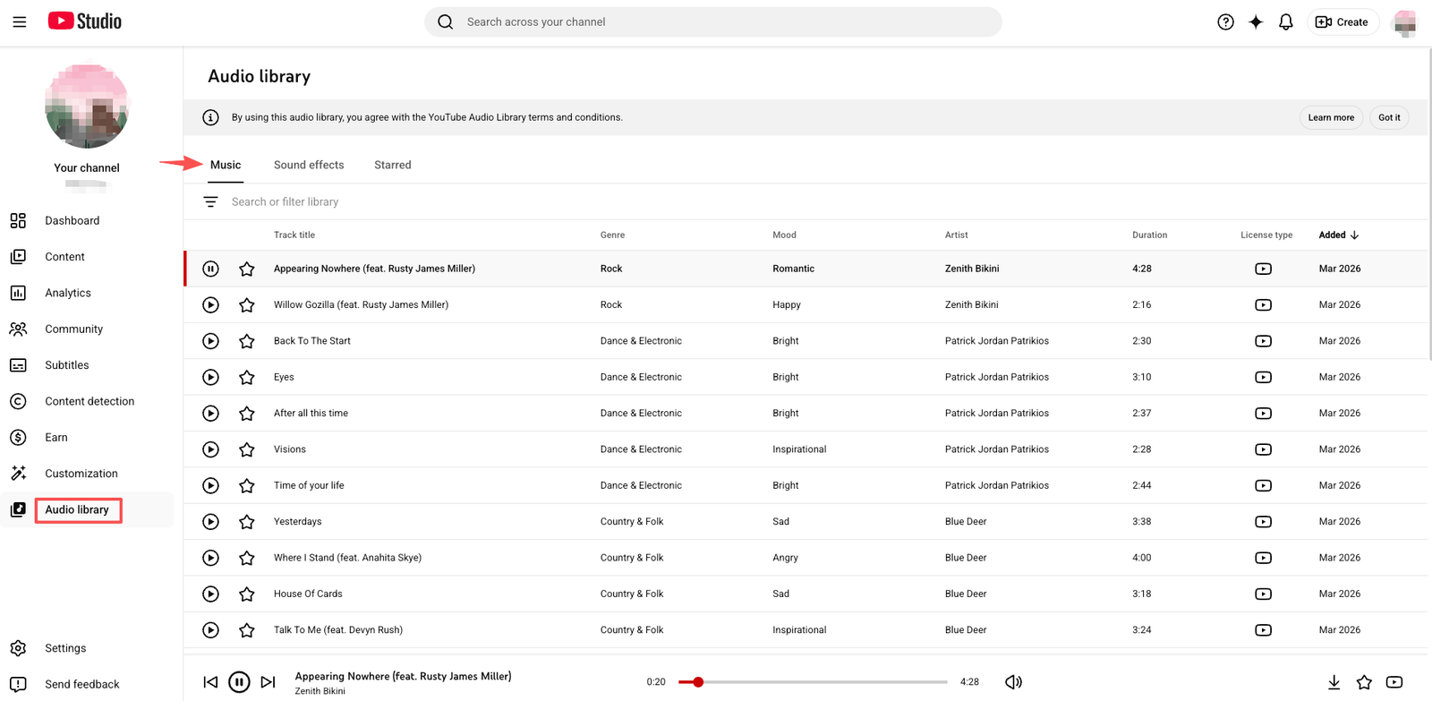 Browsing the YouTube Audio Library for royalty free background music holiday track files.