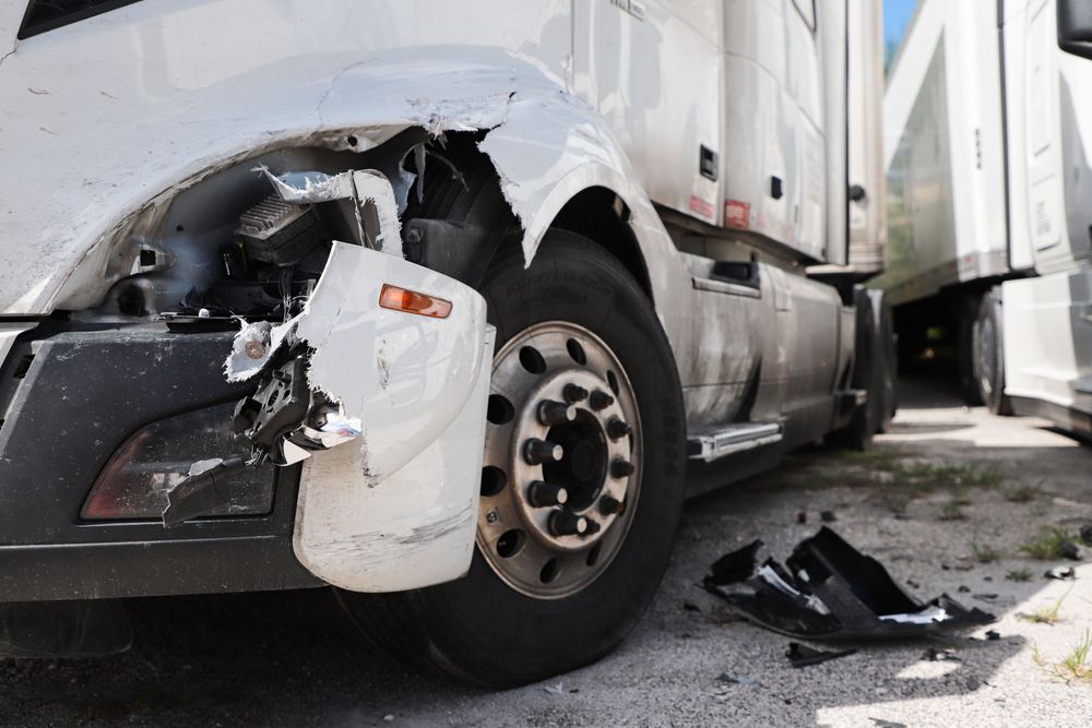 Semi-truck accident with damage to the cab and headlight