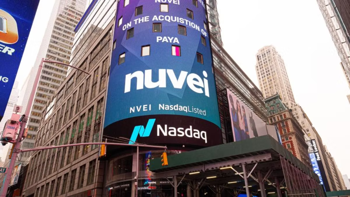 The Nasdaq tower in Times Square carrying a Nuvei billboard congratulating the company on its acquisition of Paya, with the ticker NVEI and the Nasdaq logo below.