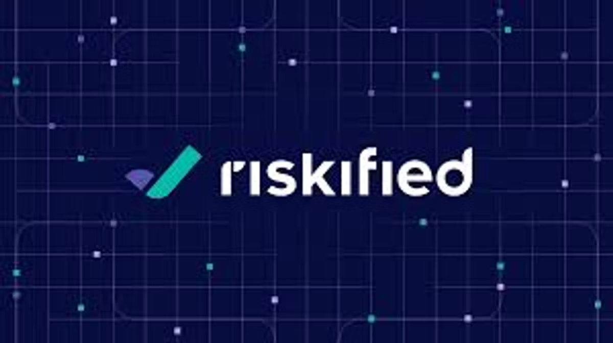 The Riskified logo in white on a dark navy background patterned with faint circuit lines and dots.