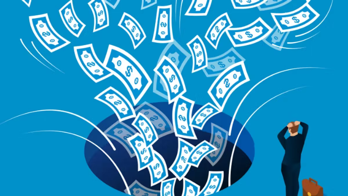Illustration of dollar banknotes swirling down into a dark hole in a blue floor while a man in a suit stands beside it clutching his head, a briefcase at his feet.