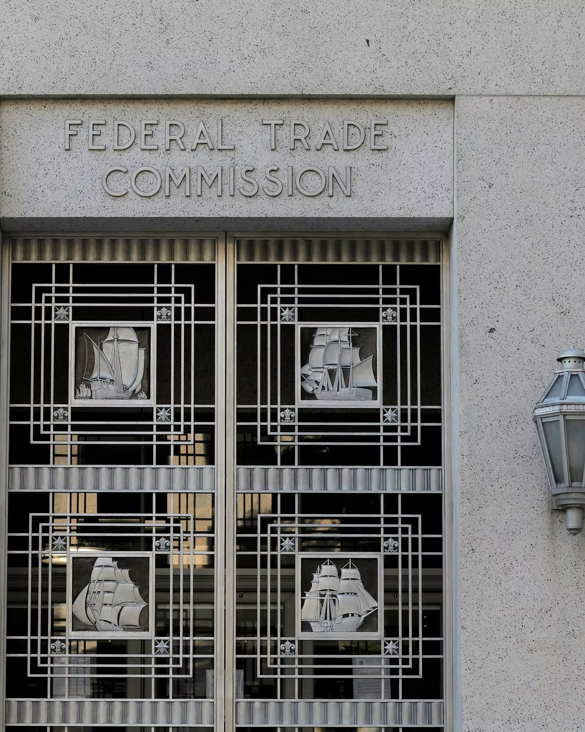 Federal Trade Commission building entrance with art deco ship window grilles and a stone facade.