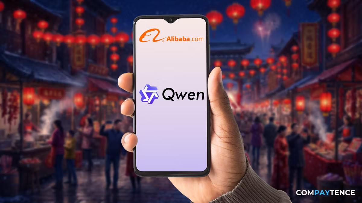 Hand holding phone displaying "Alibaba.com" and "Qwen" logos. Background shows a festive street with red lanterns and people, creating a lively mood.