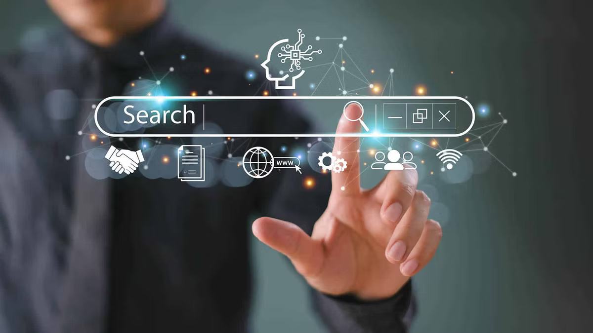 A man in a dark shirt touches a floating search bar projected in front of him, ringed by glowing icons for AI, documents, the web, settings, users and wifi.