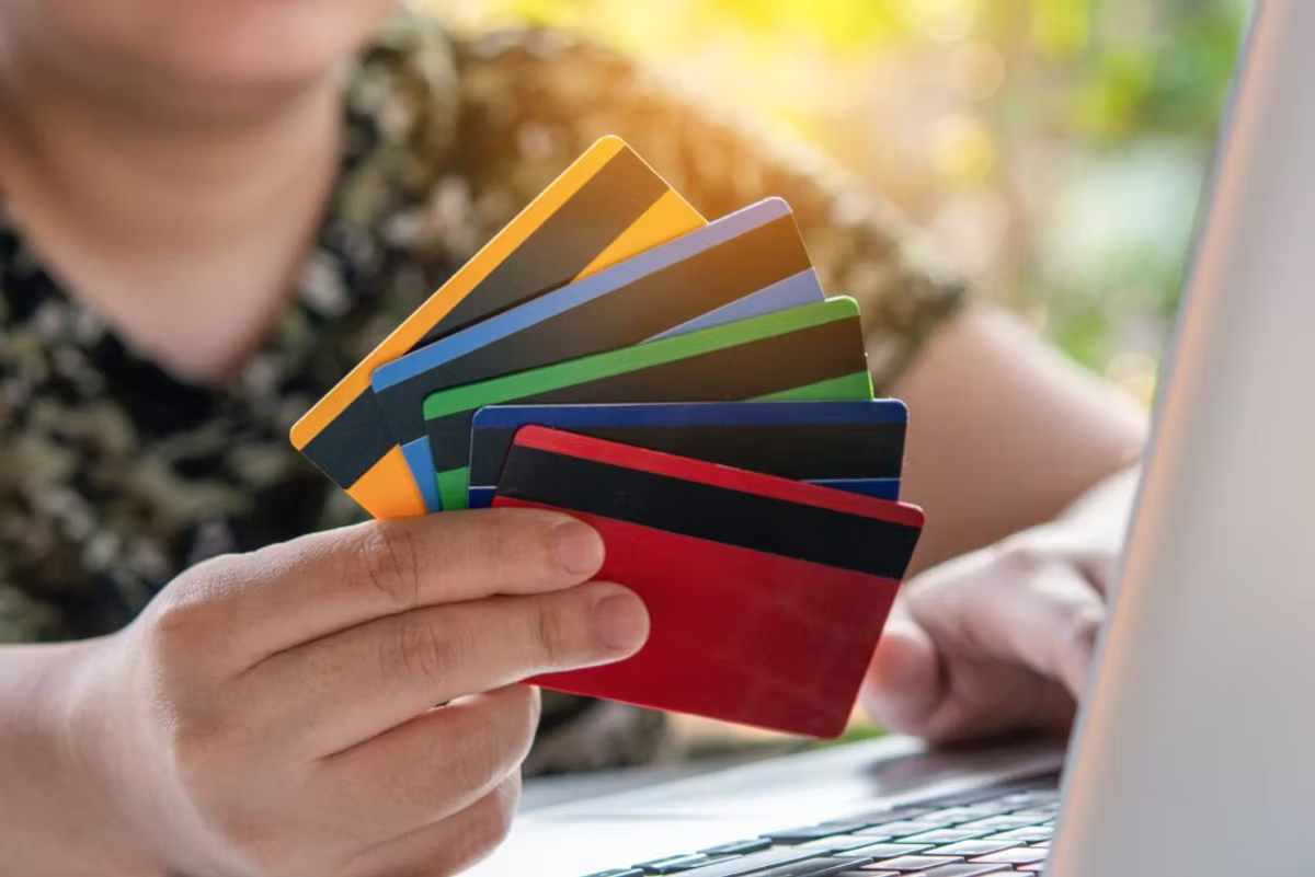 A man deciding which credit card to use.