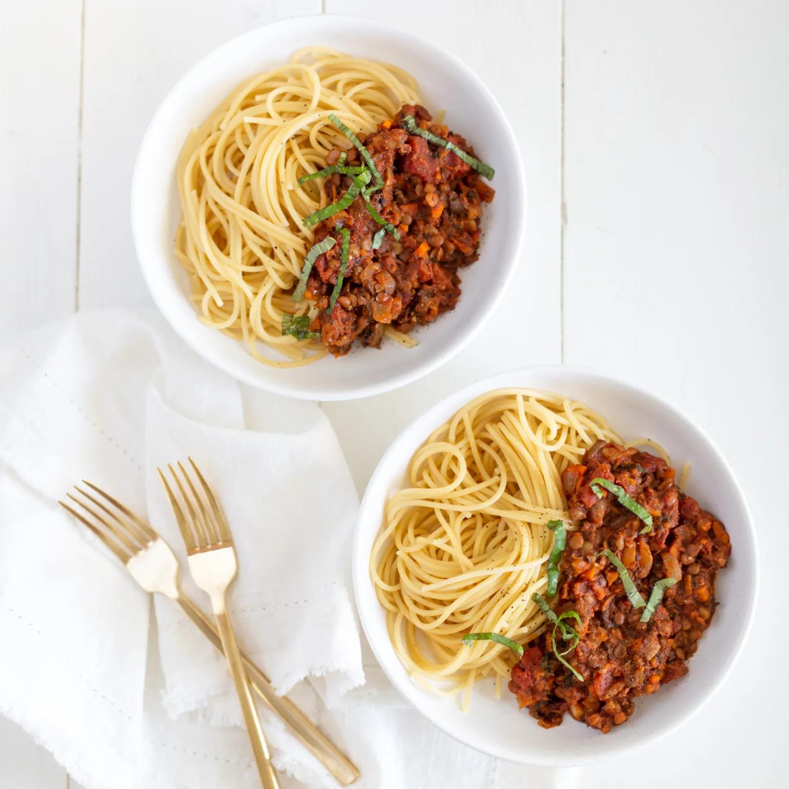 spaghetti and meat sauce in a white bowl