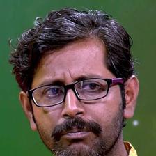 Rajesh Sharma in glasses and a yellow shirt, close-up portrait