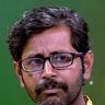 Rajesh Sharma in glasses and a yellow shirt, close-up portrait